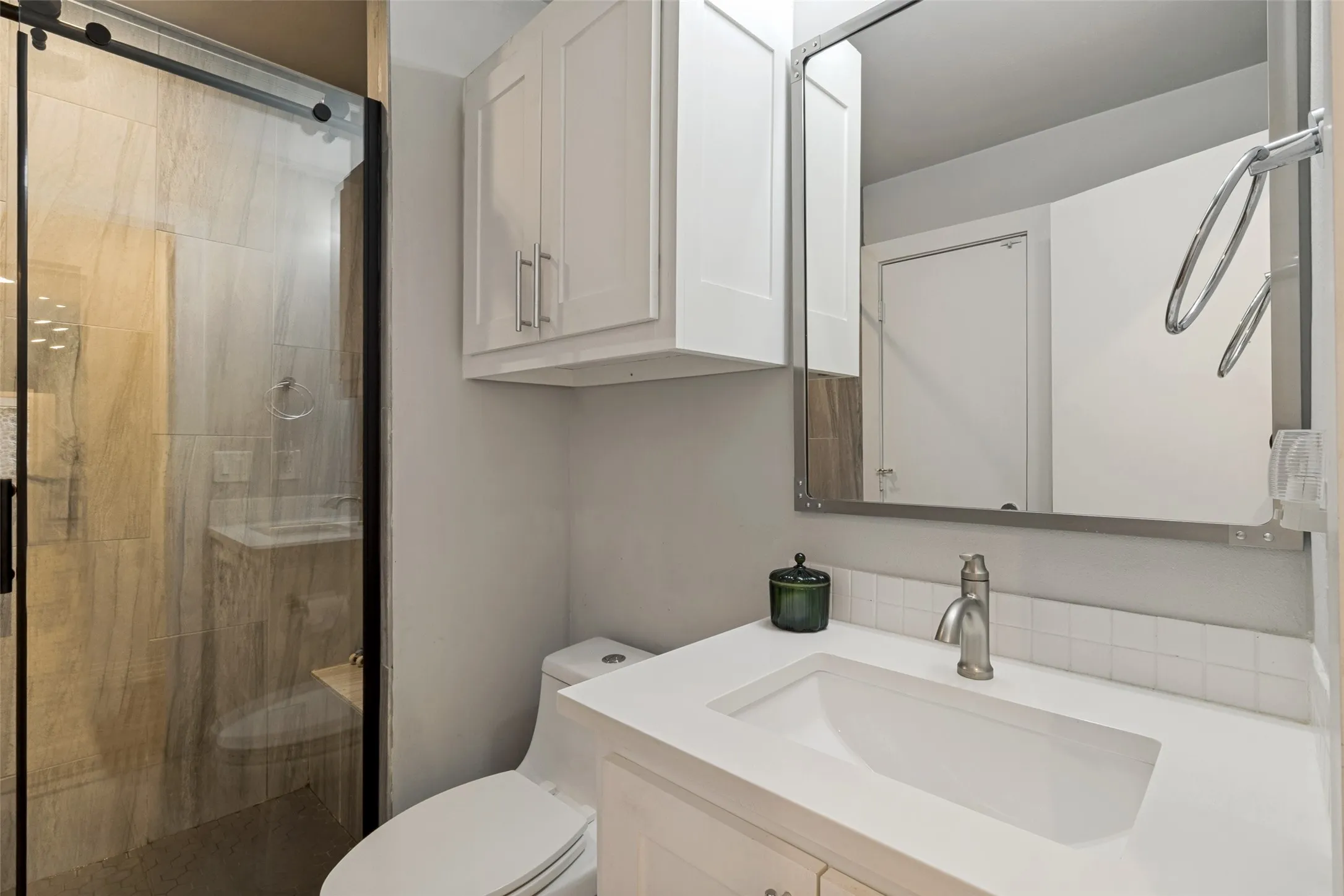 Additional updated full bath showcases modern finishes and contemporary vanity with storage.
