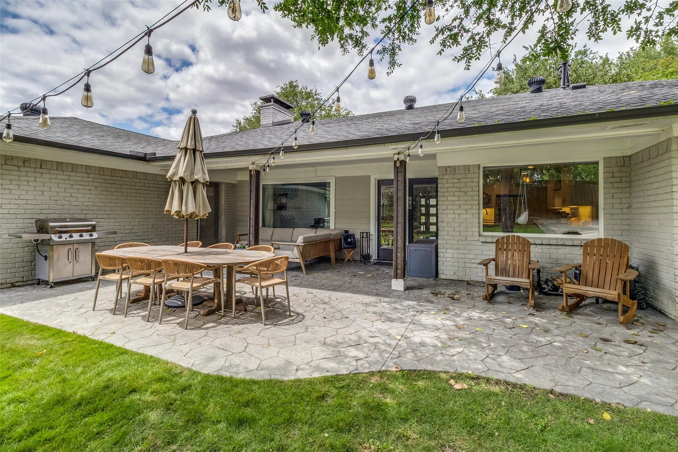 Incredible backyard retreat offers multiple seating and dining areas with seamless indoor-outdoor flow from the main living spaces.