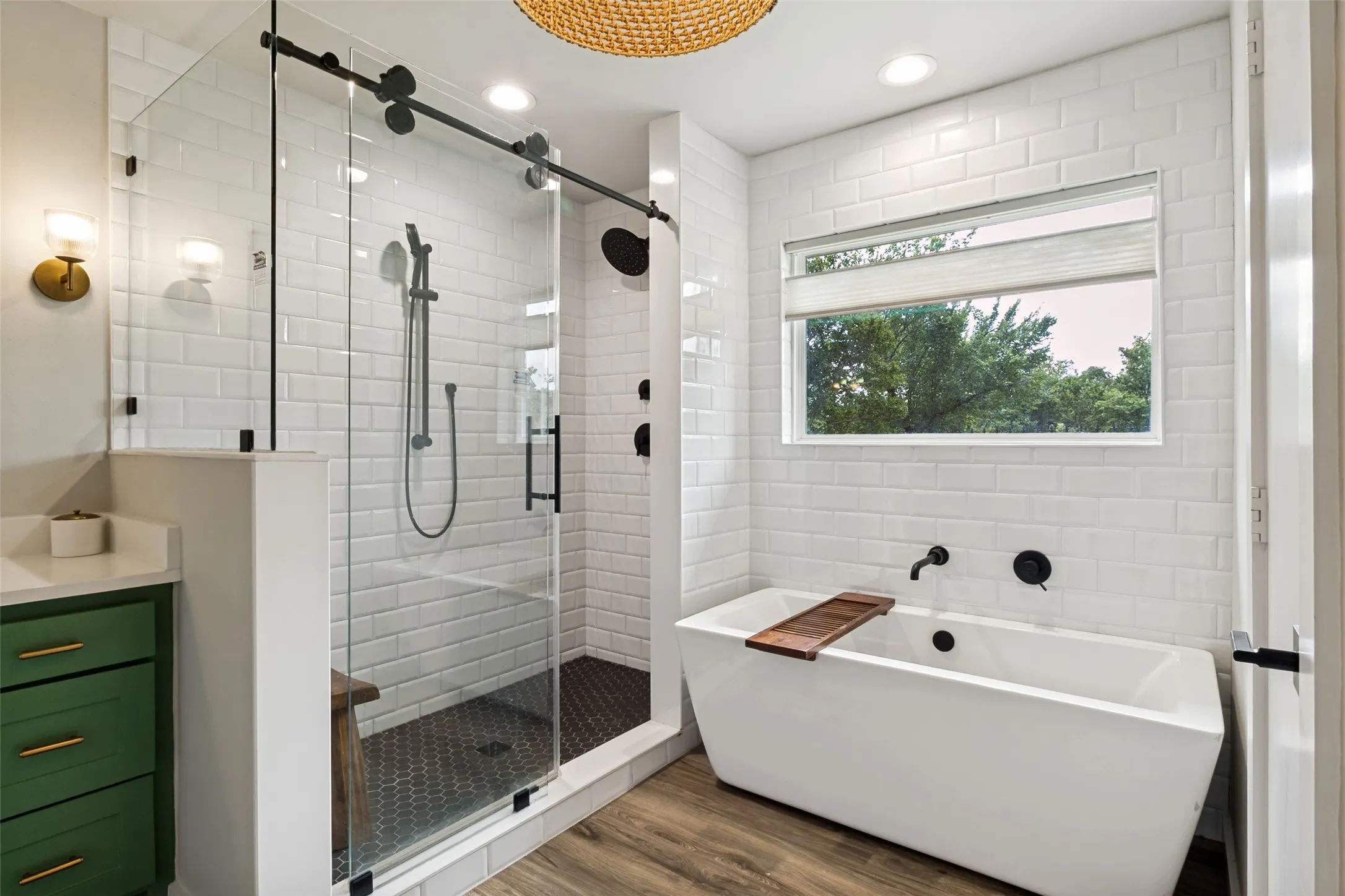 Oversized walk-in shower with frameless glass enclosure pairs beautifully with the freestanding soaking tub for a true retreat-like feel.