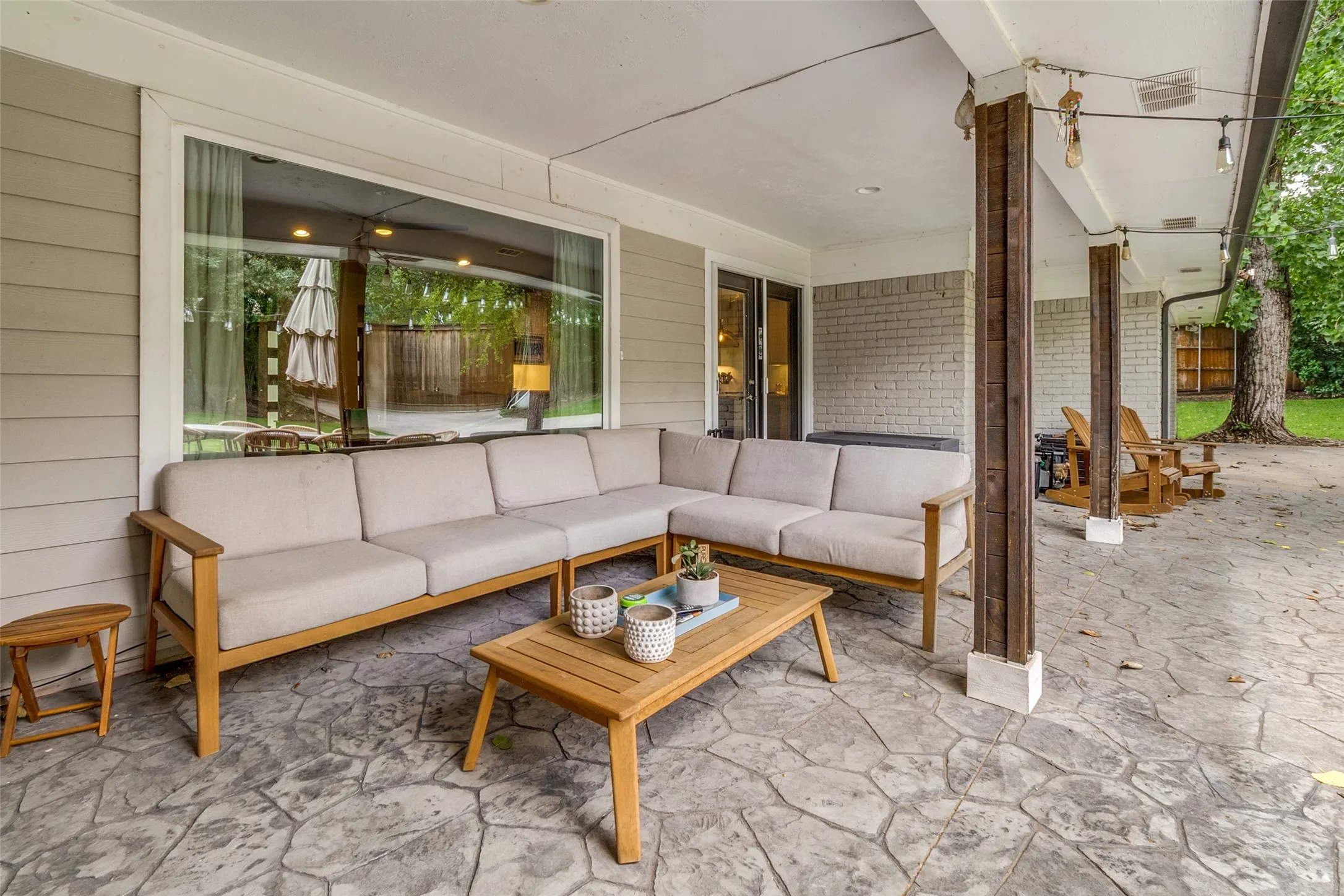 Expansive covered stamped concrete patio creates the perfect outdoor living space for relaxing, dining, and entertaining year-round.