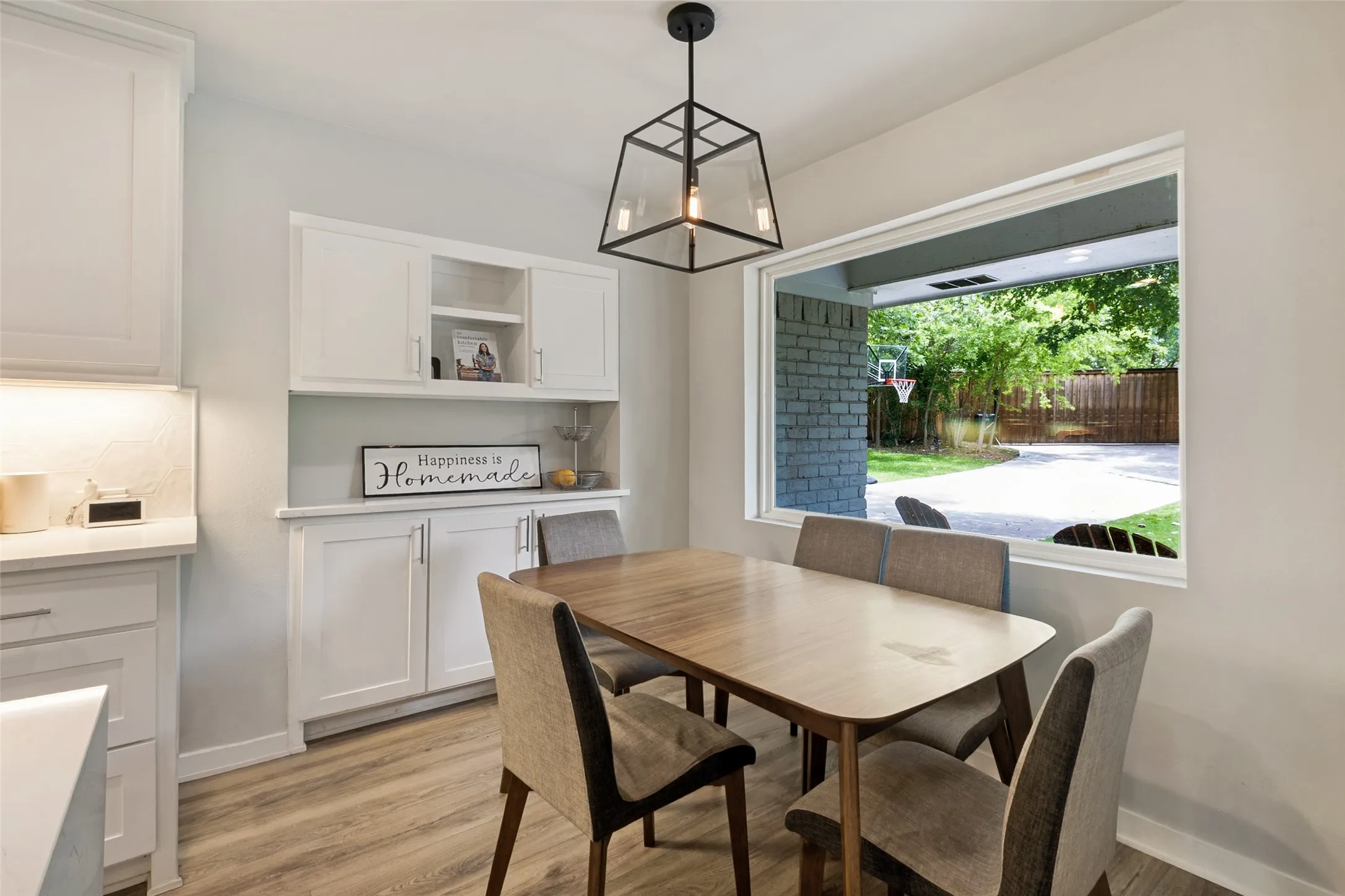 Sunny breakfast nook offers the perfect spot for morning coffee or casual meals while overlooking the beautifully landscaped backyard.