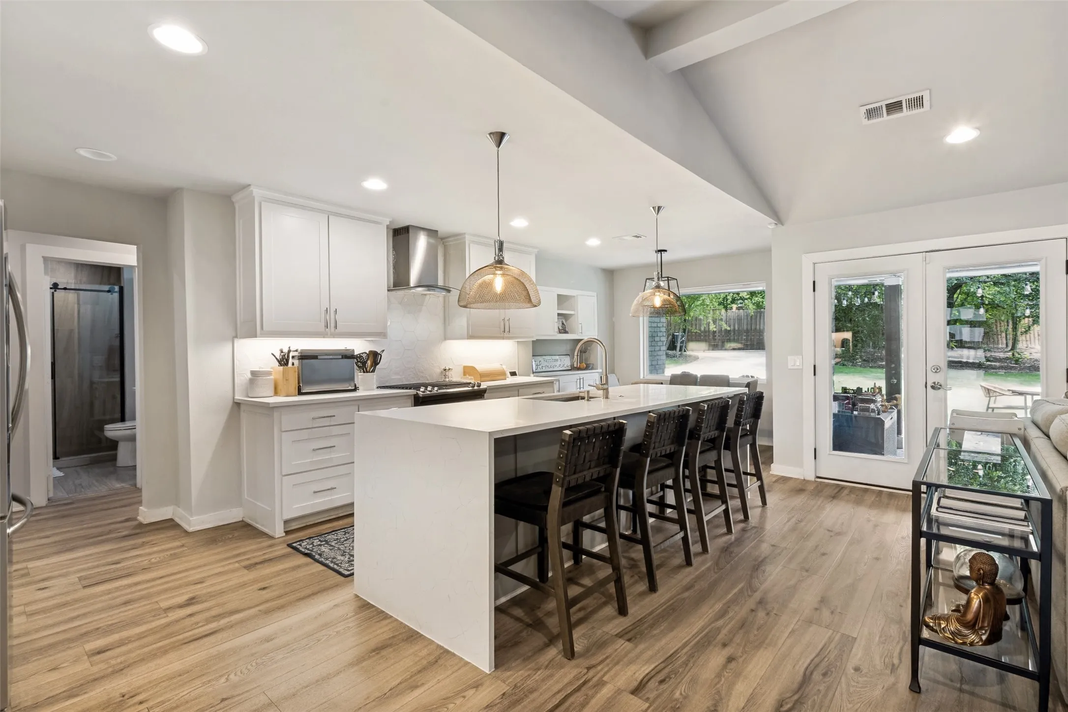 Large center island with seating anchors the heart of the home, blending style and functionality for everyday living and entertaining alike.