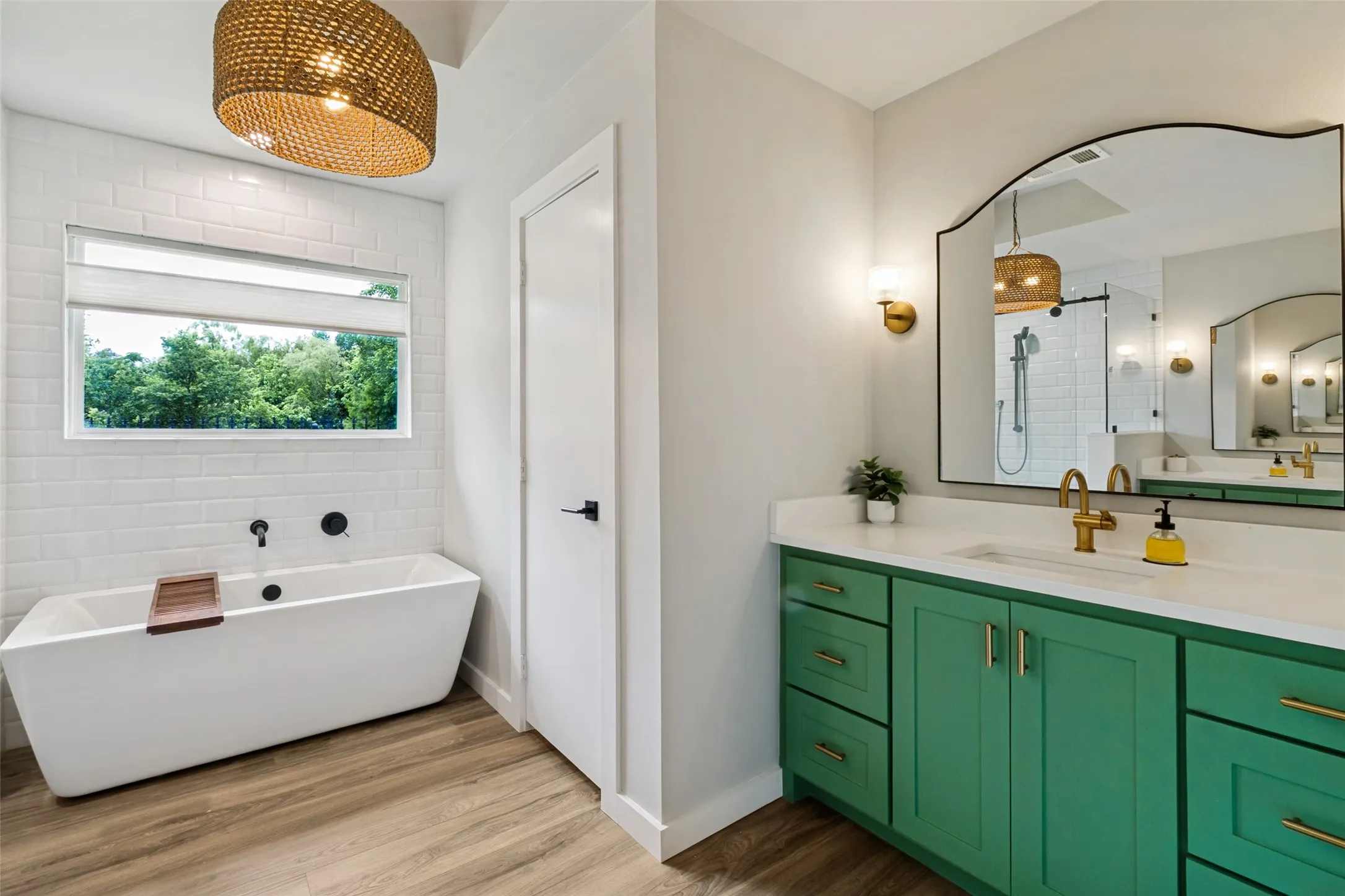 Thoughtfully renovated primary ensuite combines bold designer touches with timeless functionality and abundant natural light.
