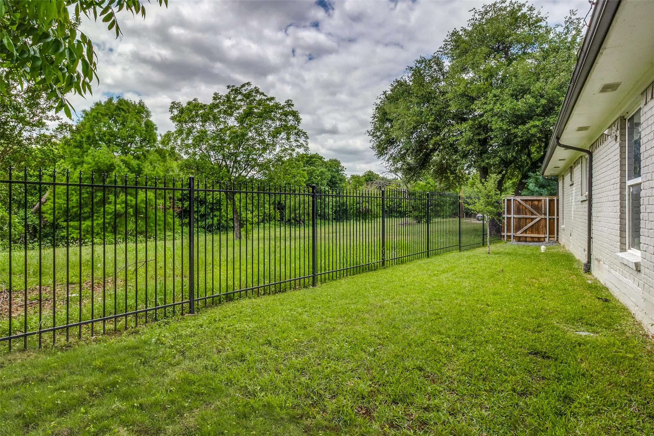 Property backs to city-owned greenspace, offering added privacy, scenic views, and a more secluded feel than typical city living.
