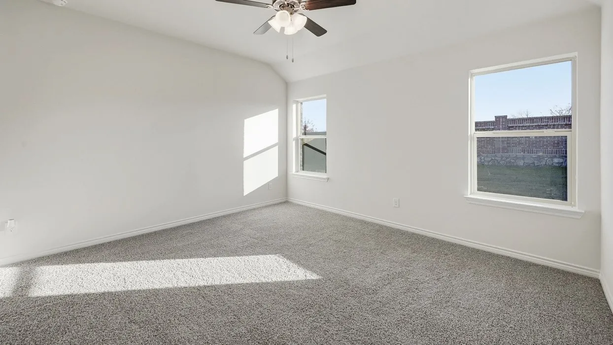 Expansive room featuring gray carpeting and white painted walls