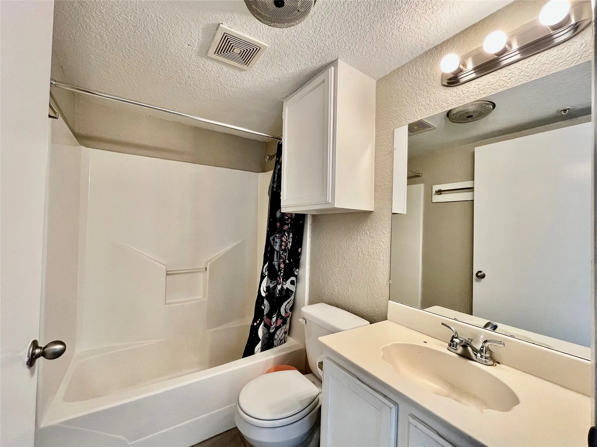 Bathroom. Notice the large mirror and the tub/shower combo.