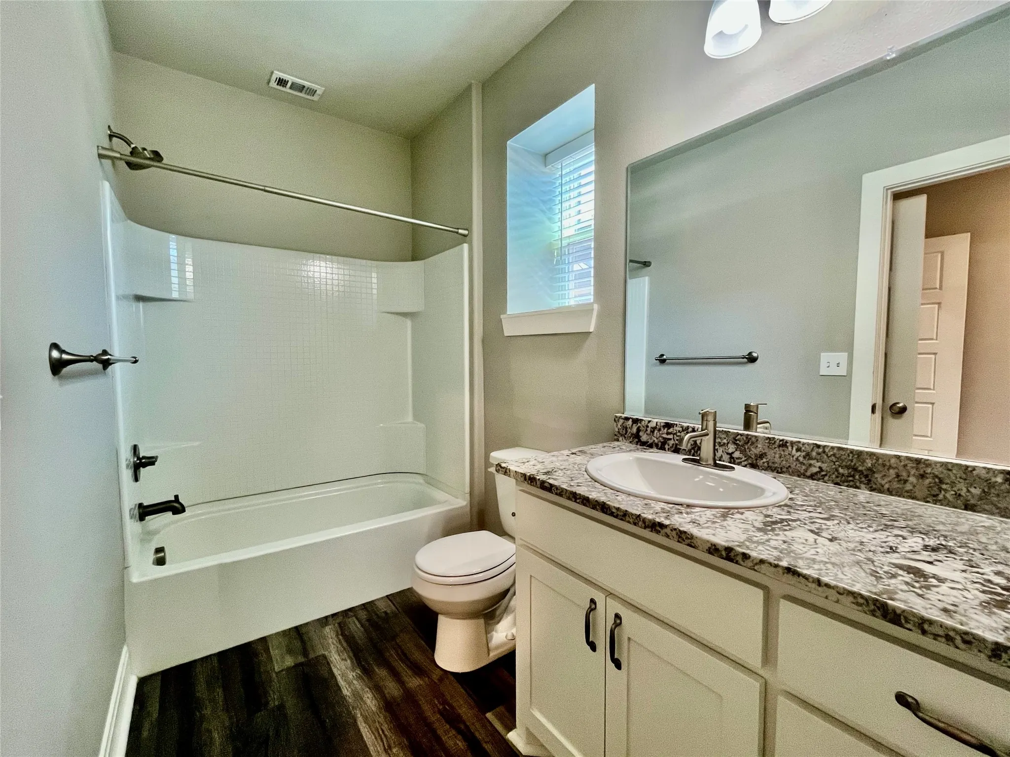 Stylish bathroom boasting a modern vanity with a beautiful granite countertop.