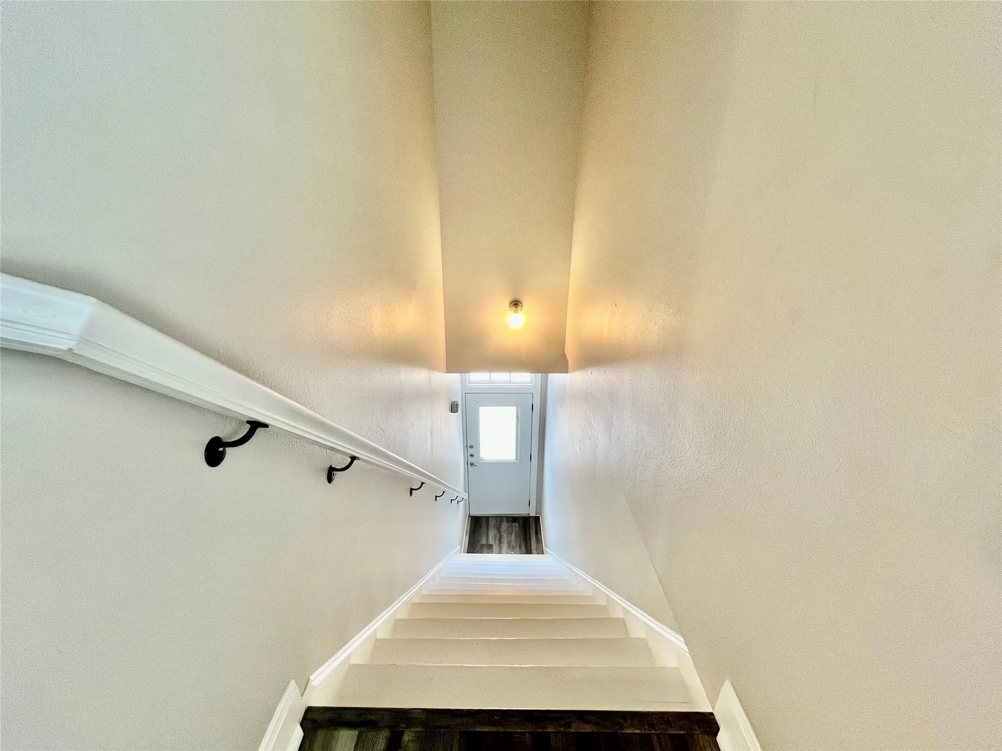 Bright and inviting stairway leading up into the main living spaces.