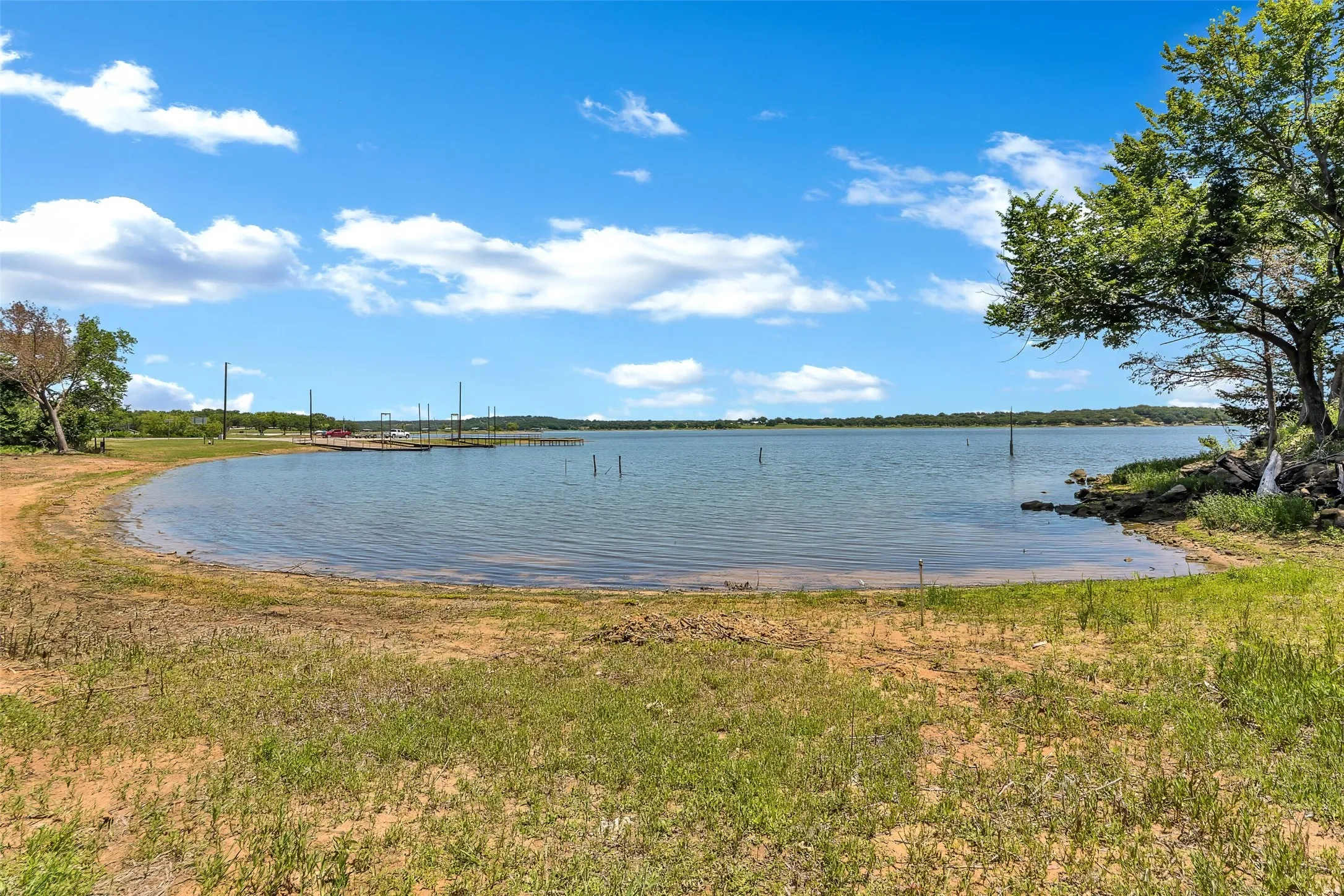 Expansive waterfront property featuring a natural shoreline, mature trees, and direct lake access