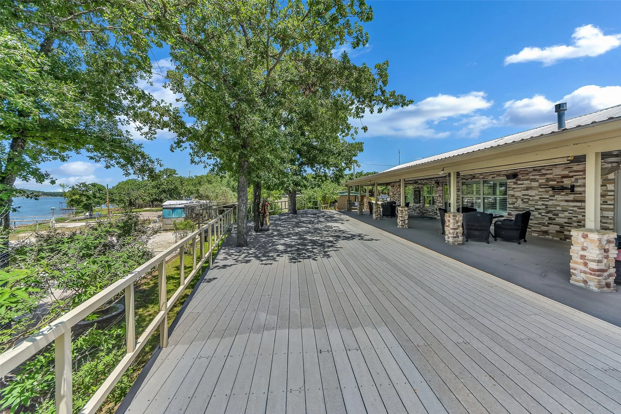 Expansive outdoor deck with composite decking and a light-colored railing