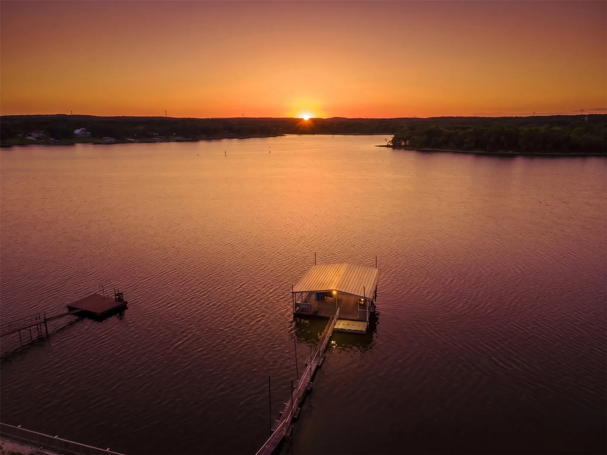 Private covered boat dock with an extended walkway and separate floating platform
