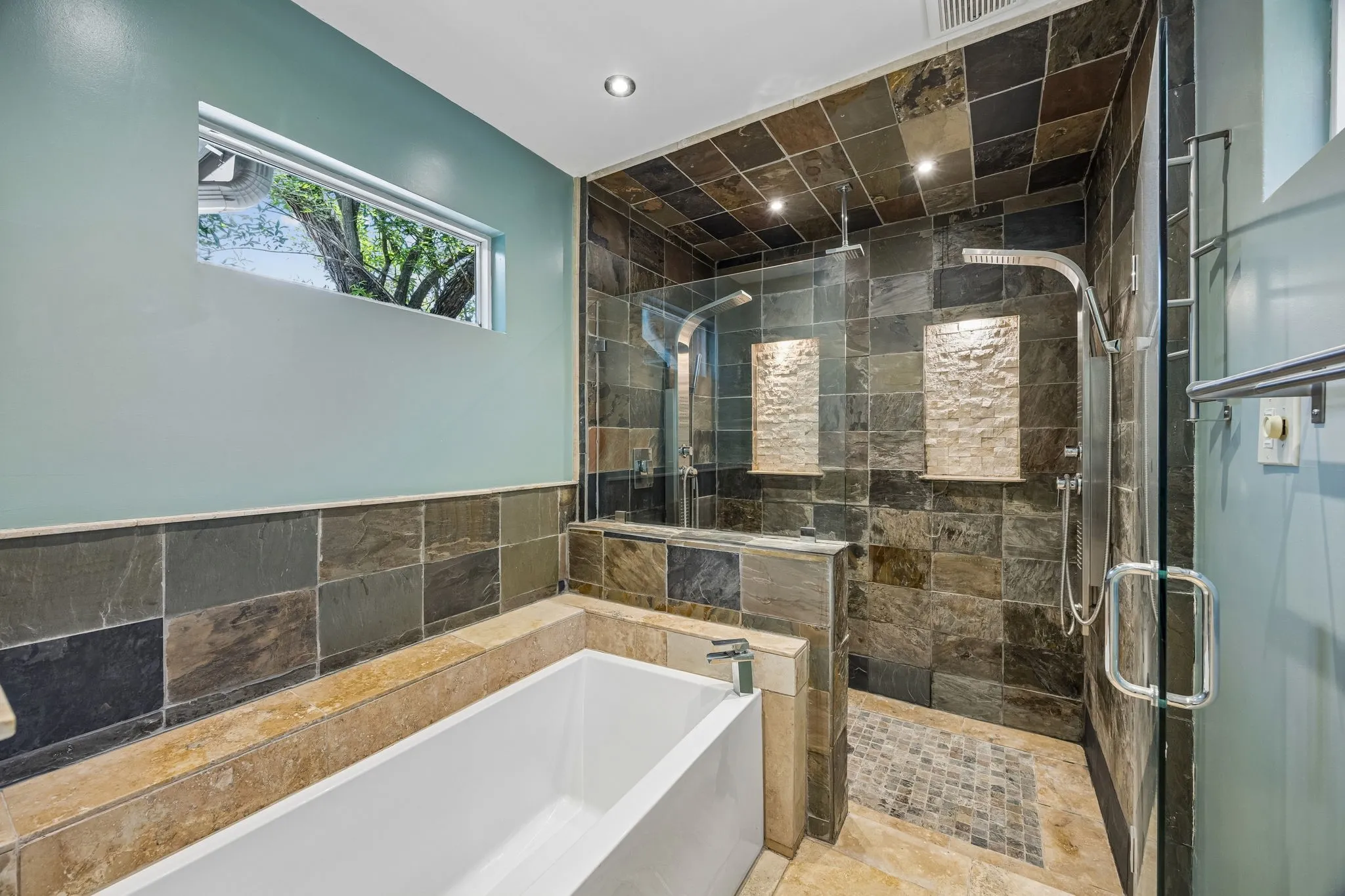Separate soaking tub & dual showers in the over-sized steam shower