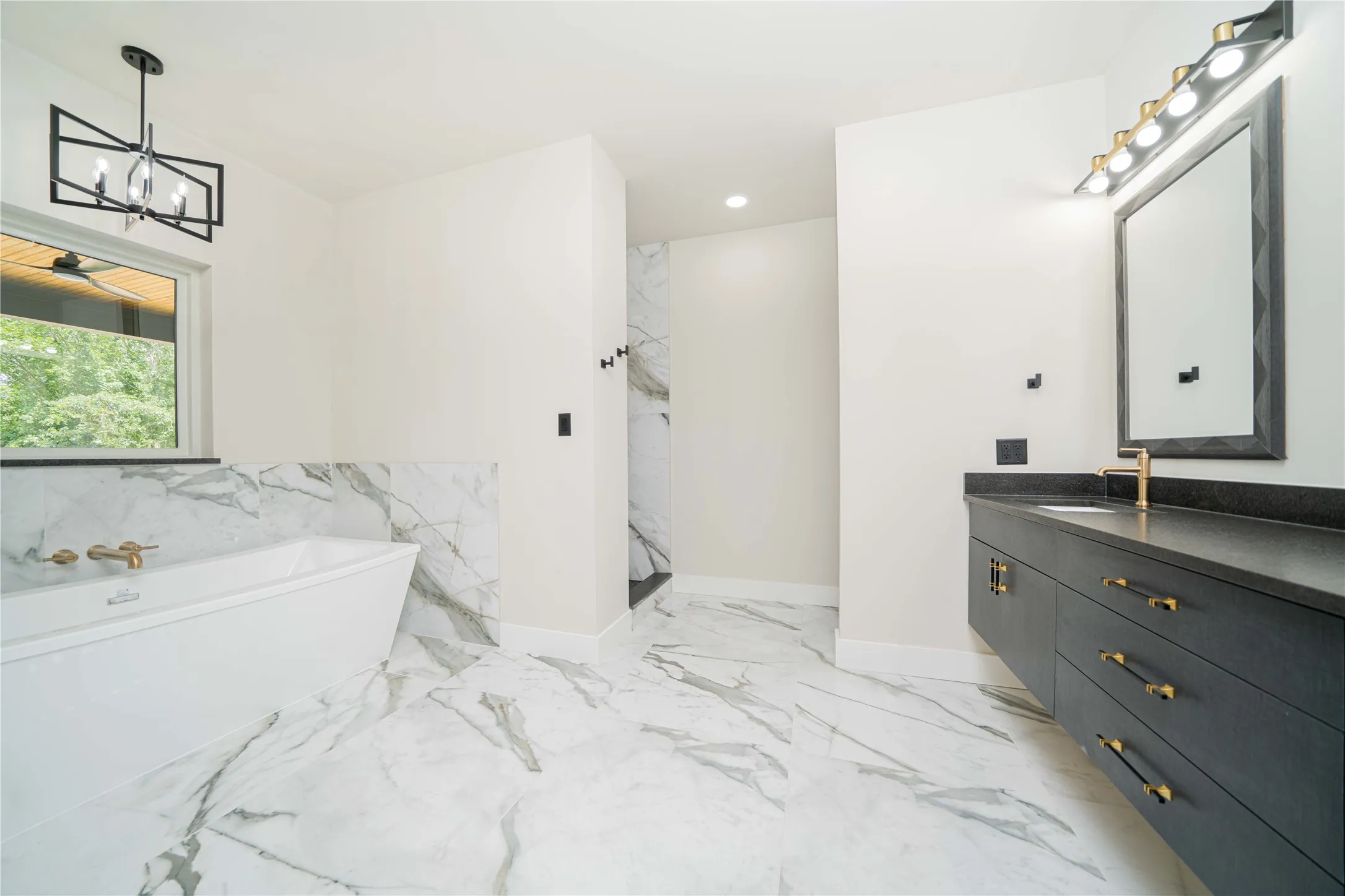 Bathroom with white marble-look tile flooring and wainscoting
