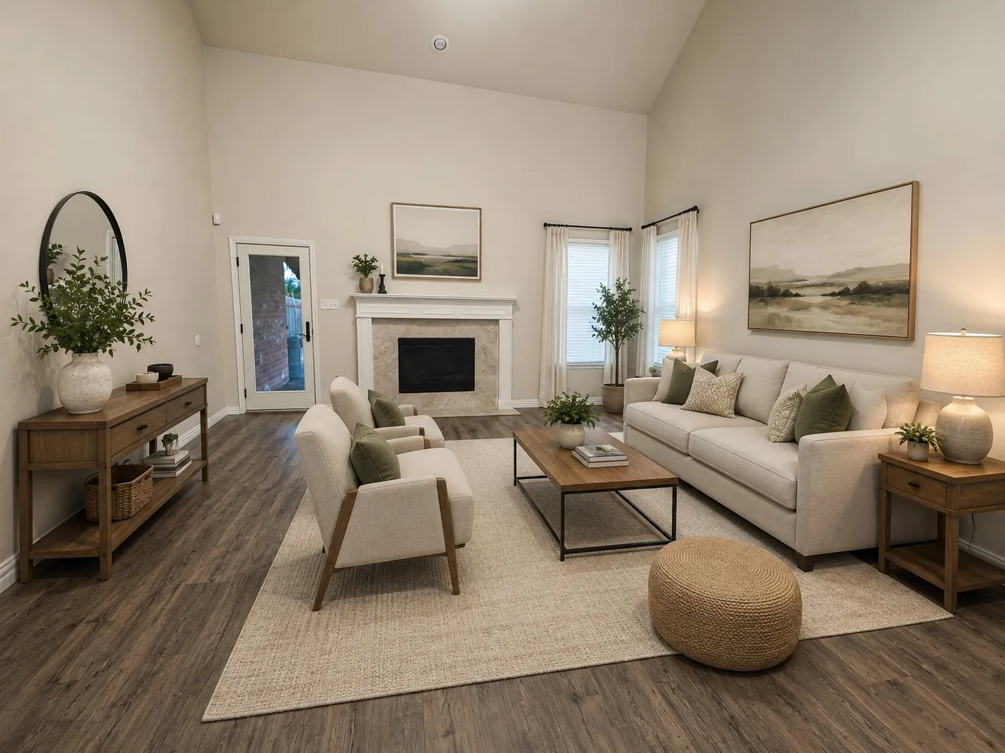 Vaulted living area featuring wood-finish flooring, a fireplace with a stone surround, and light-colored walls
