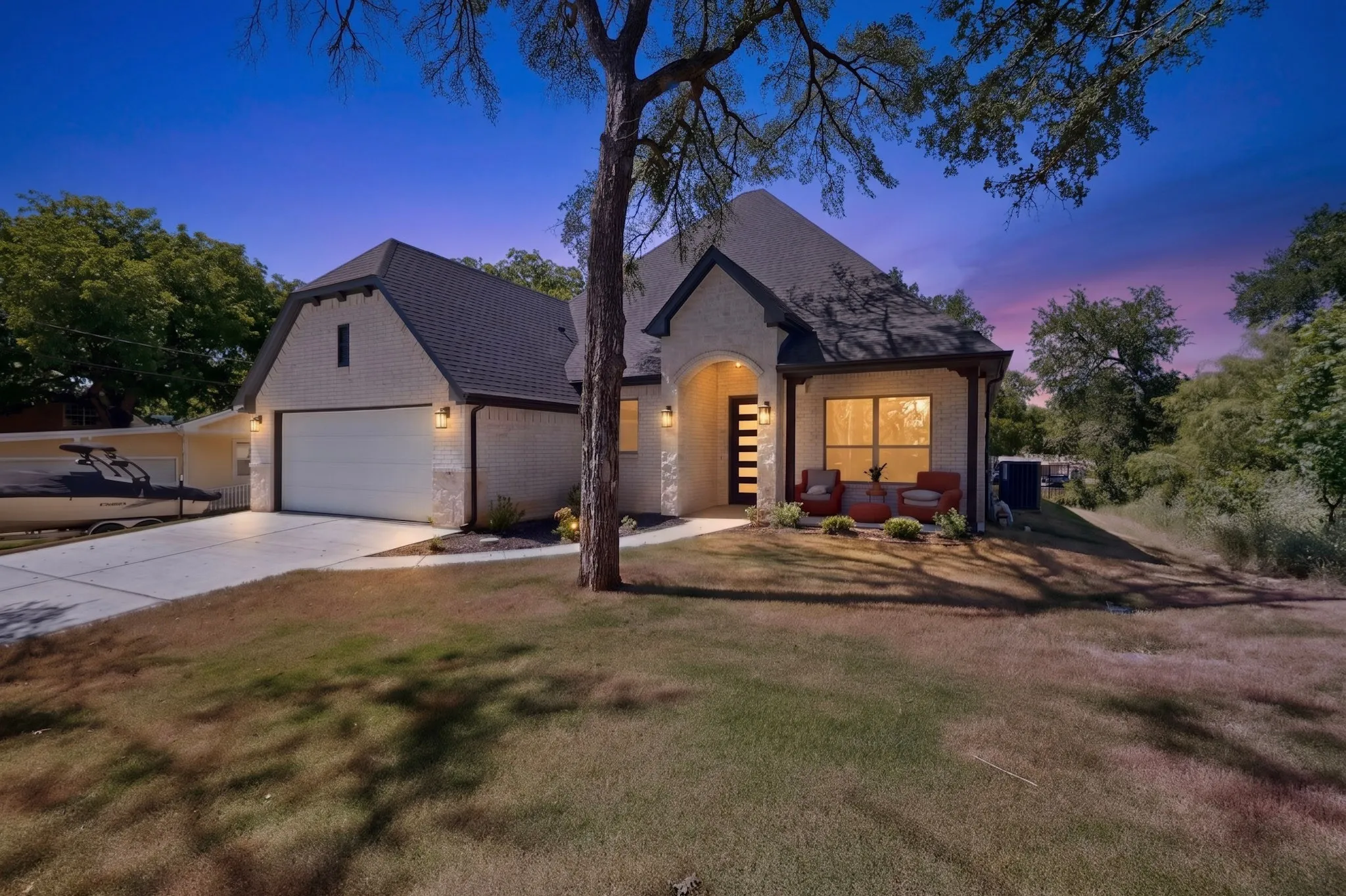 Cream brick exterior with dark trim and a gabled roofline