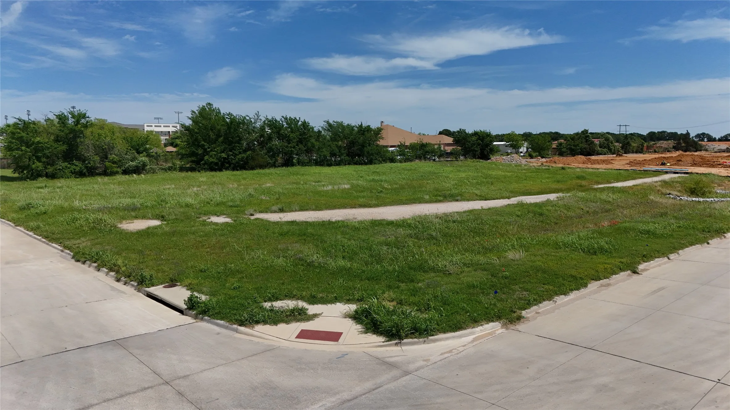 Expansive corner lot with established concrete curb and street infrastructure