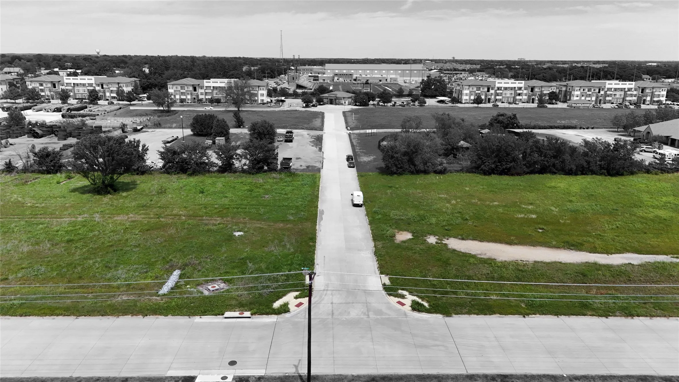 Expansive open lot with established roadways and infrastructure