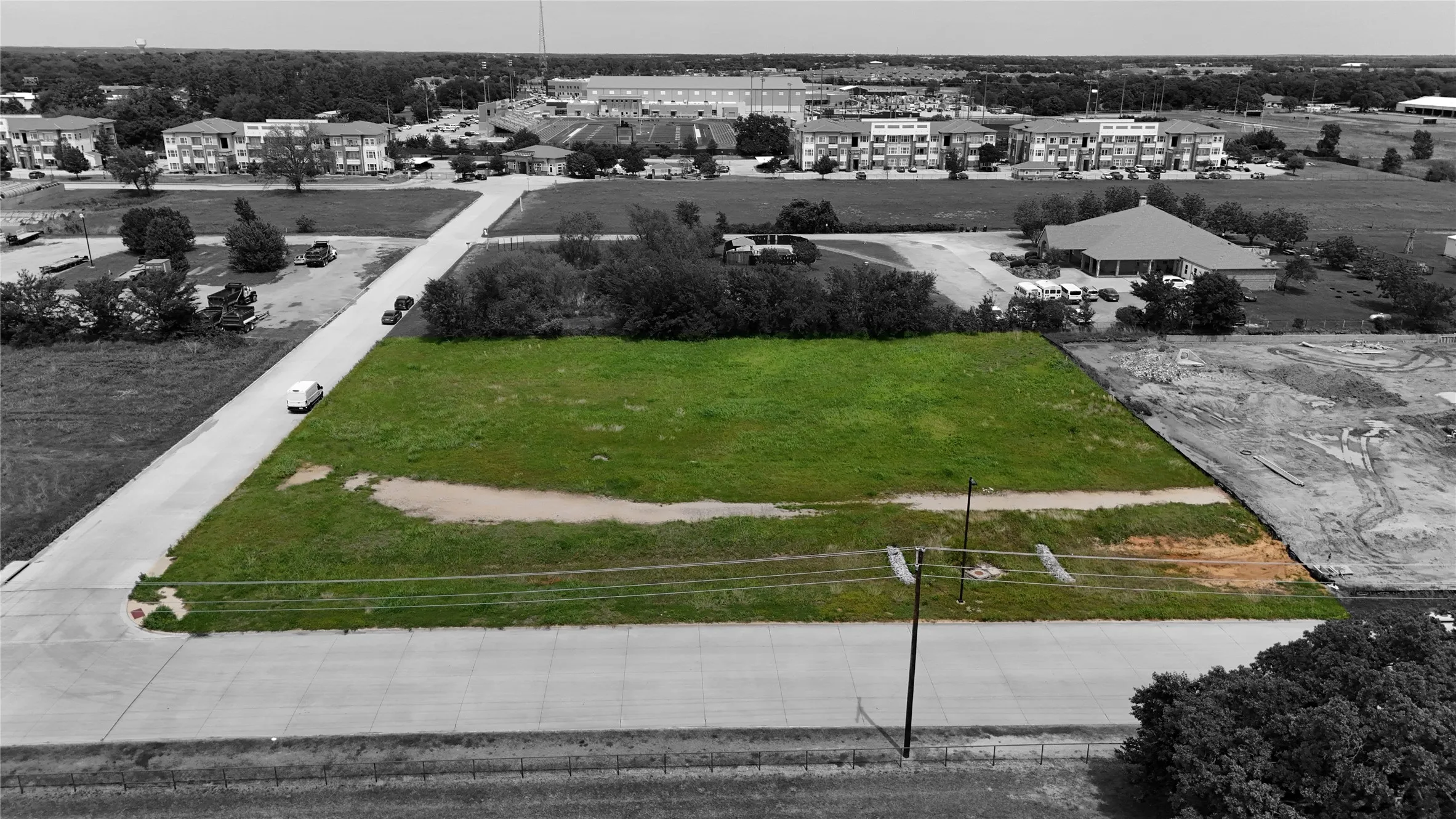 Expansive green lot with established road frontage, providing substantial space for development