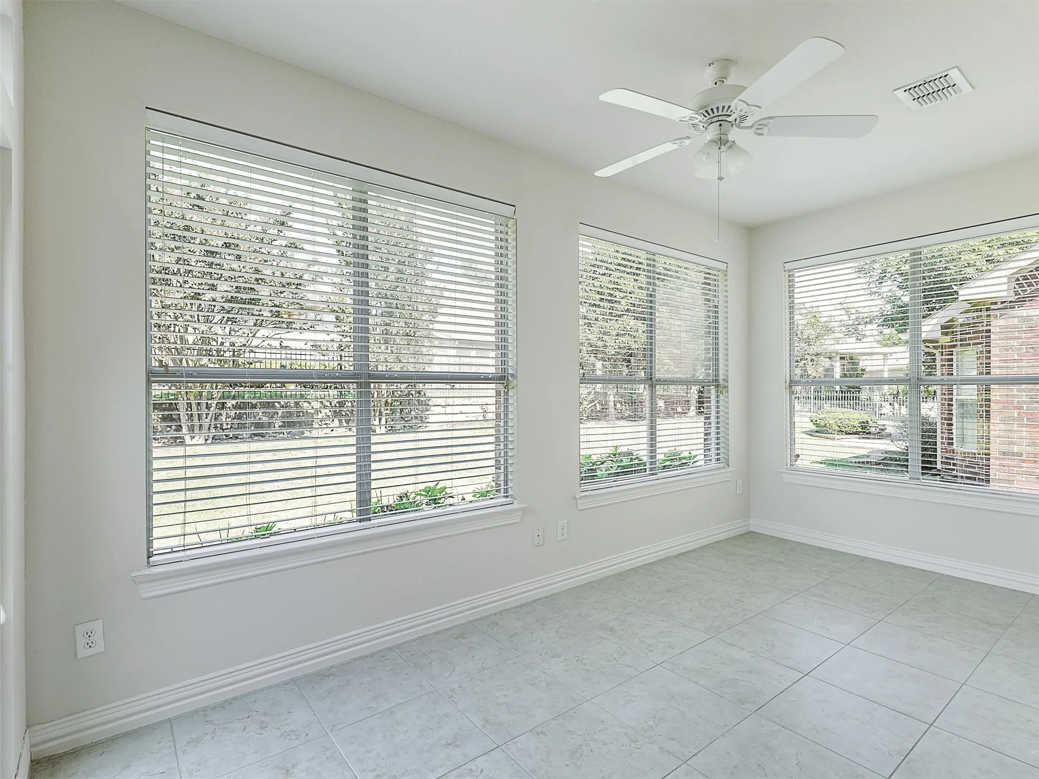 Solarium sunroom featuring tile patterned flooring and  plenty of light