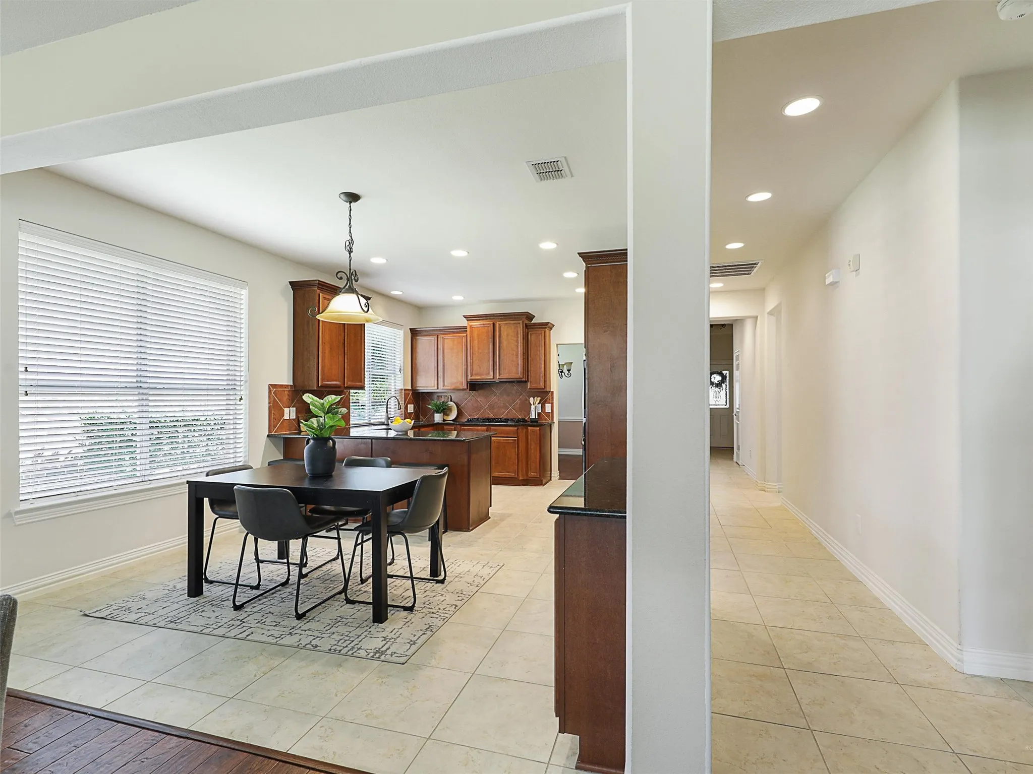 Dining area with recessed lighting and light tile patterned floors