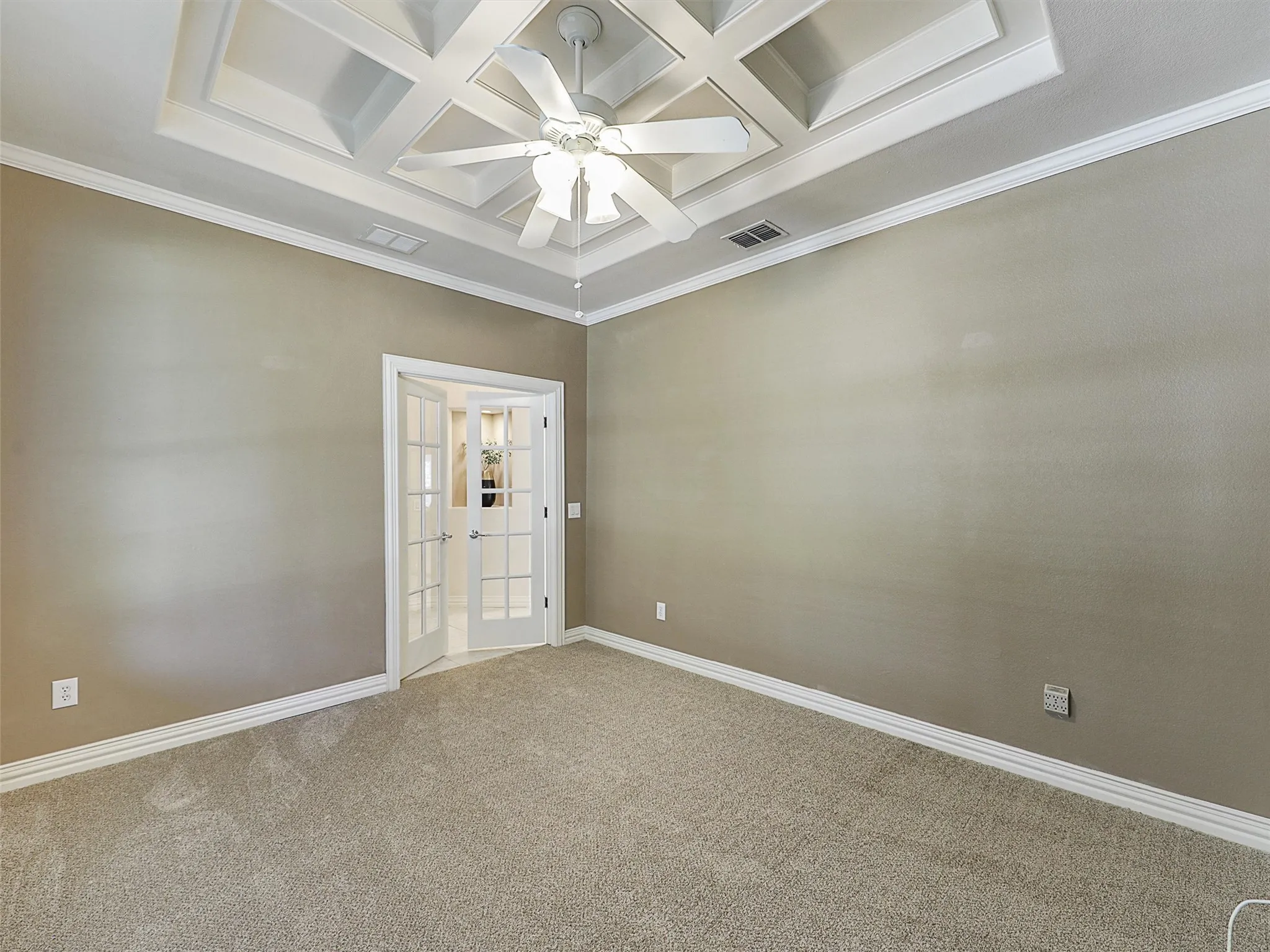 Study featuring coffered ceiling, carpet flooring, french doors, a ceiling fan, and beamed ceiling