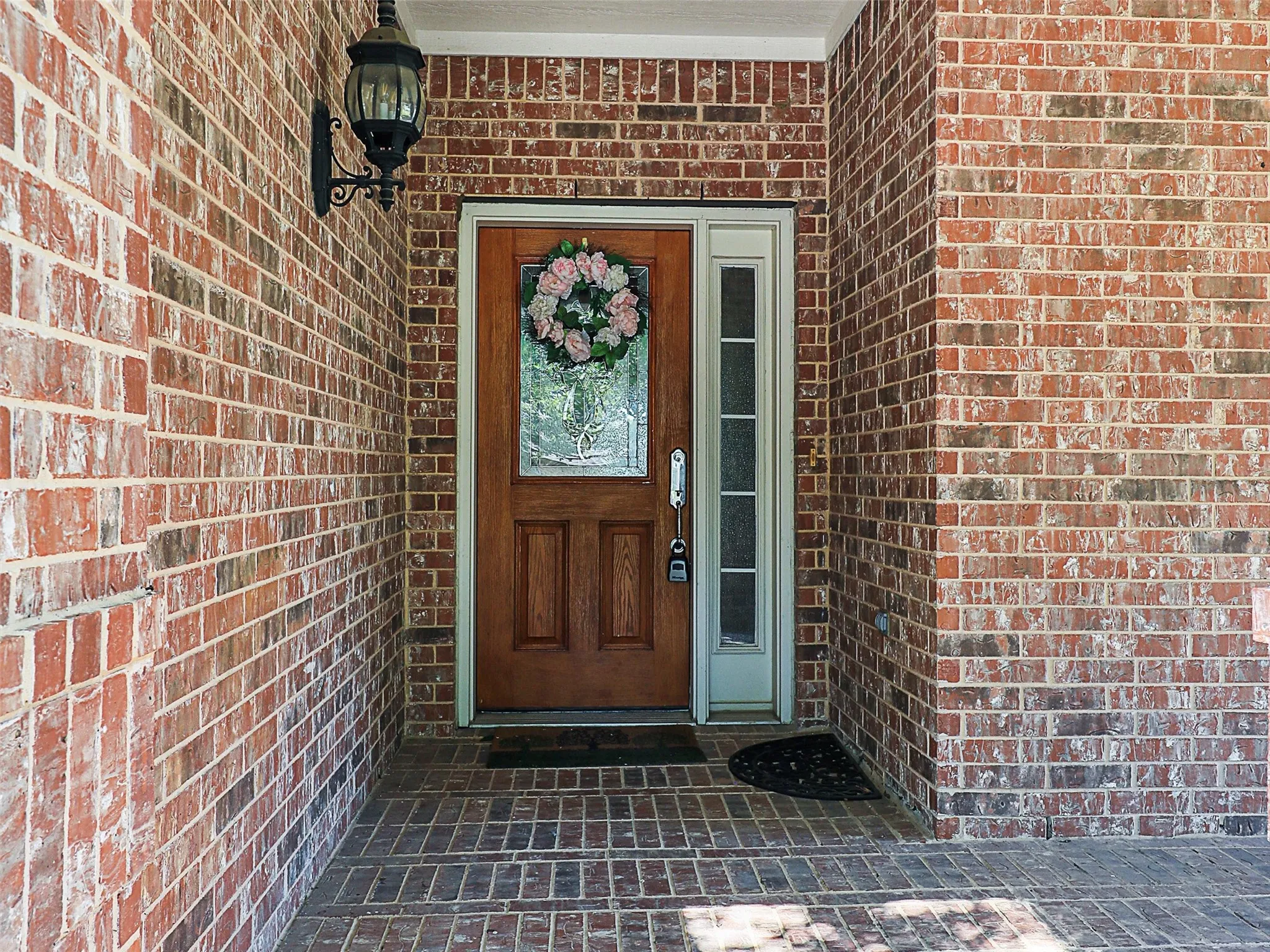 Doorway to property featuring brick siding