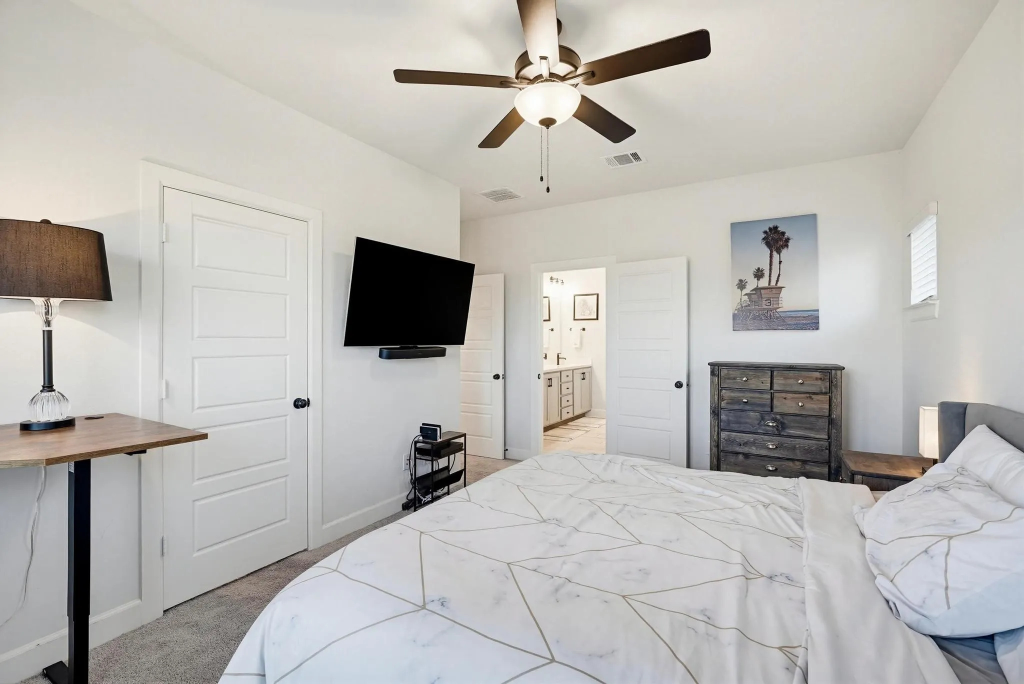 Bedroom featuring light gray carpet flooring and a ceiling fan with integrated lighting