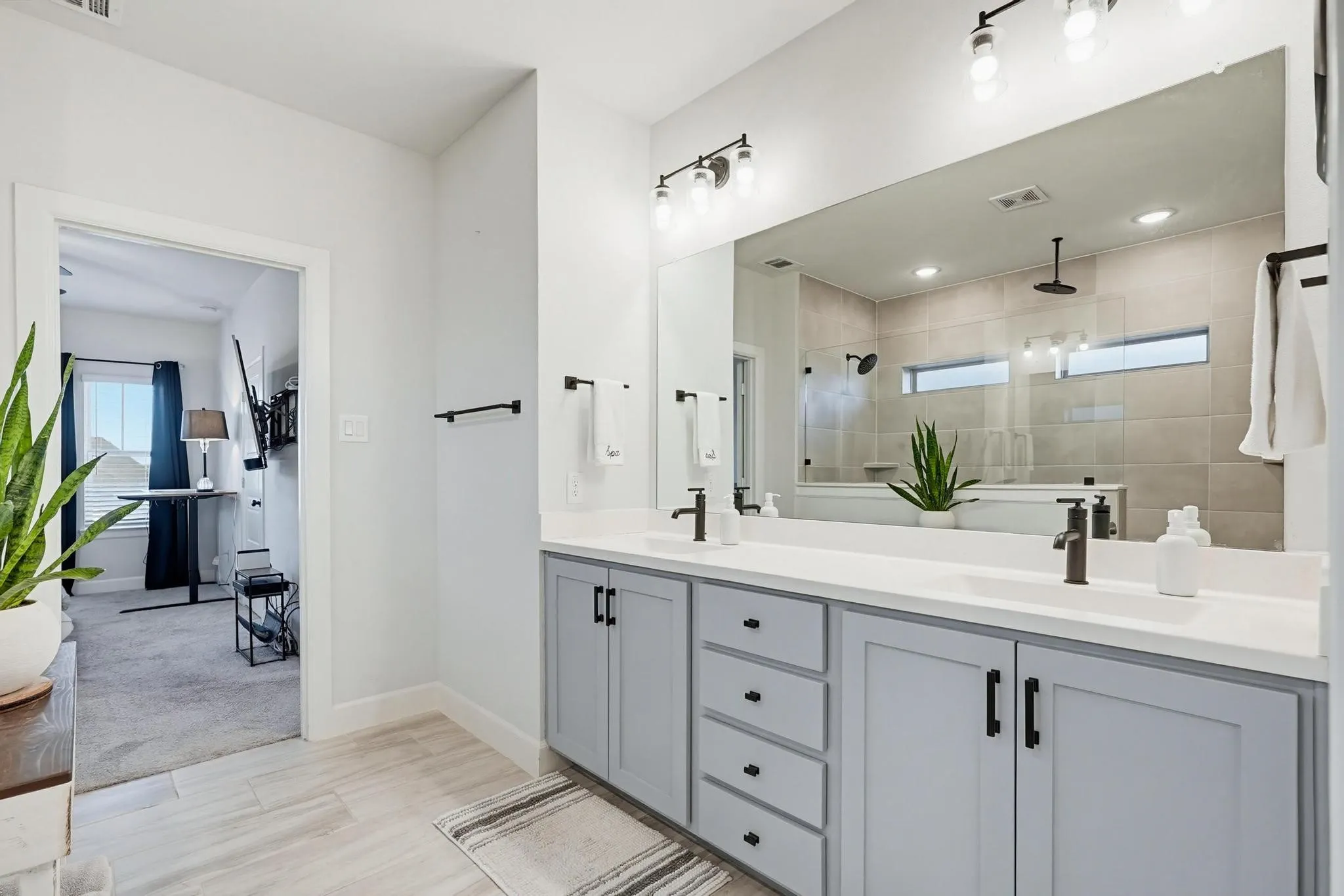 Dual vanity with light gray cabinetry and white countertops