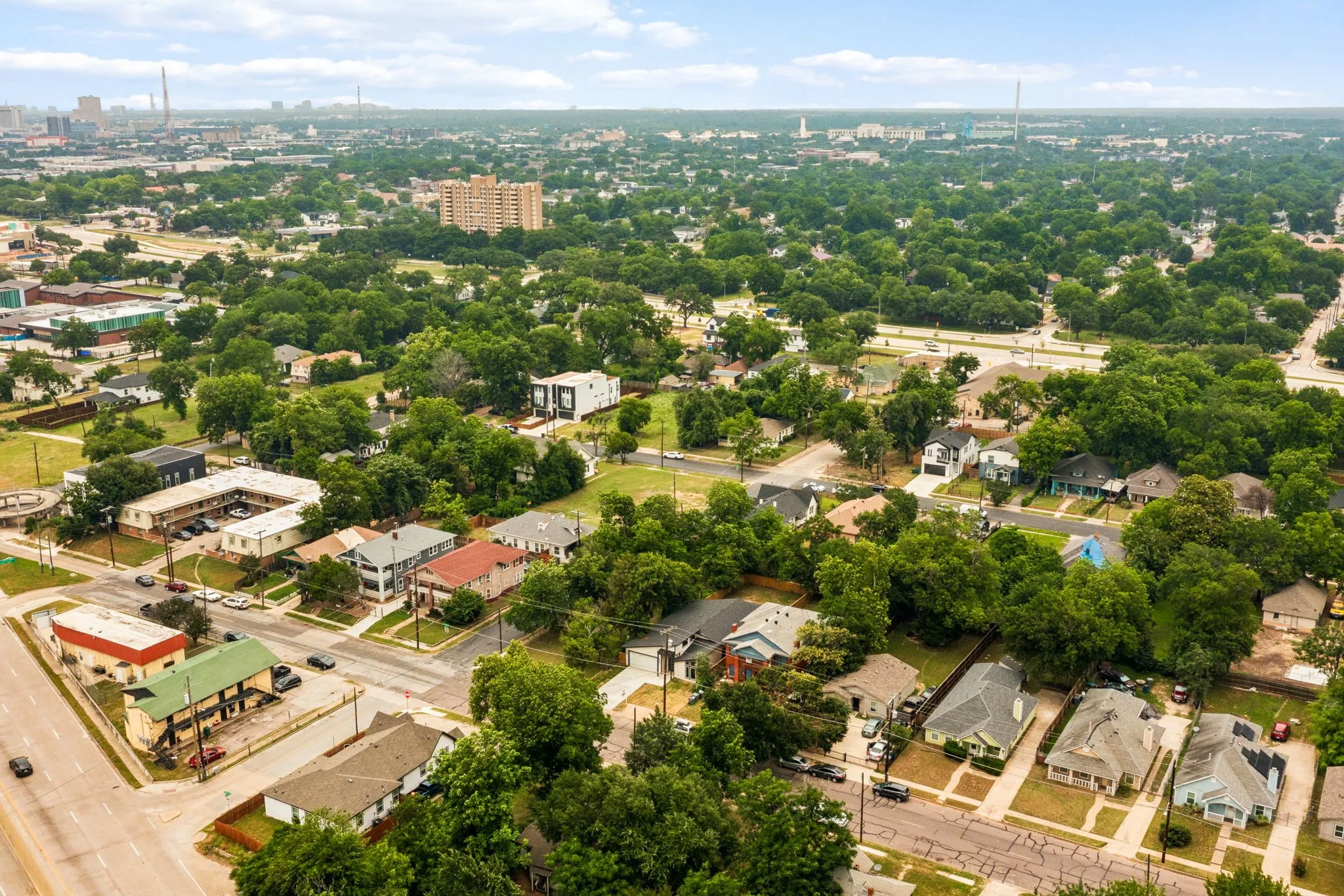 Aerial perspective showcasing a residential area with mature trees and varied architectural styles