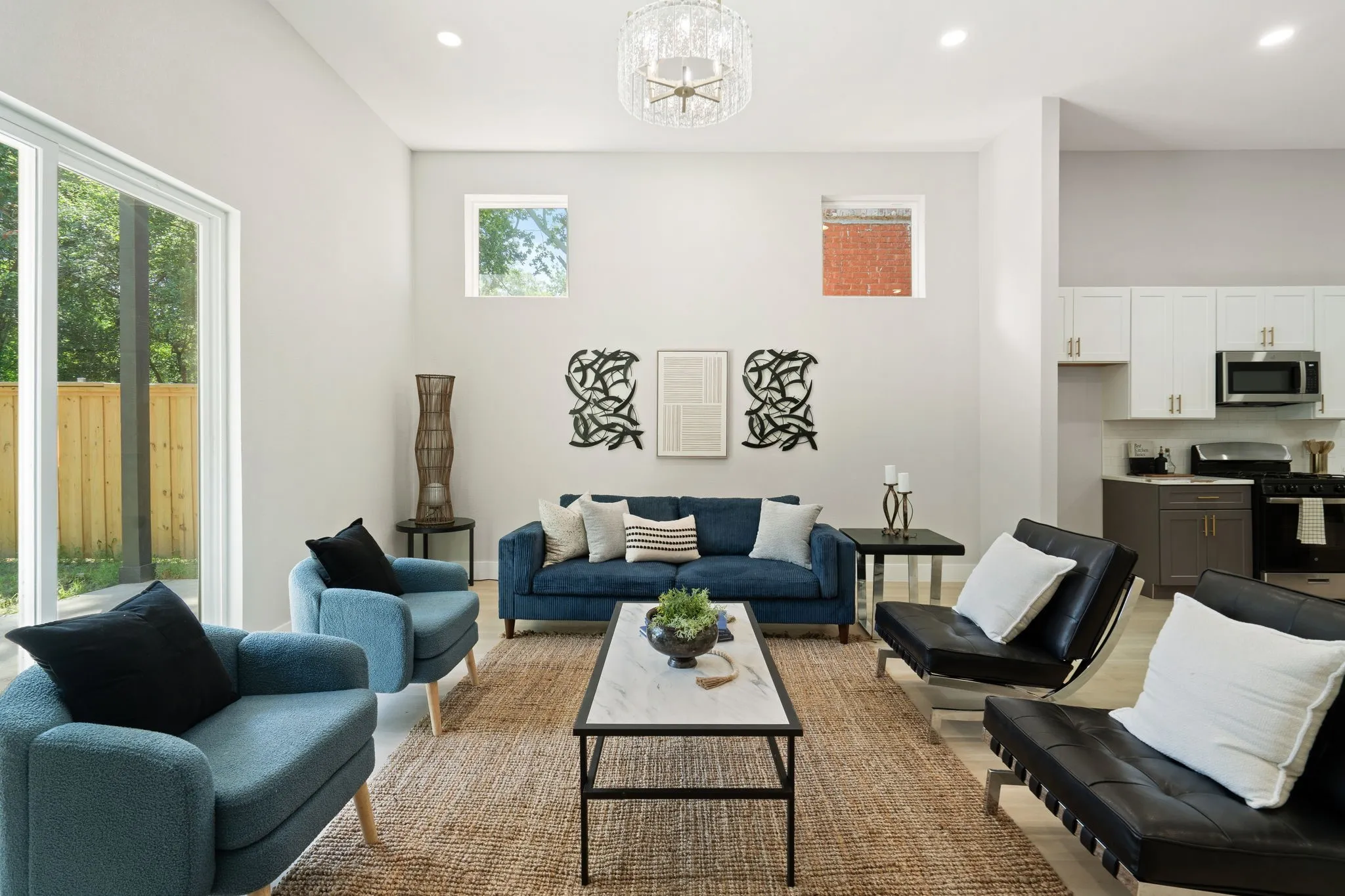 Spacious living area featuring high ceilings, recessed lighting, and a modern chandelier