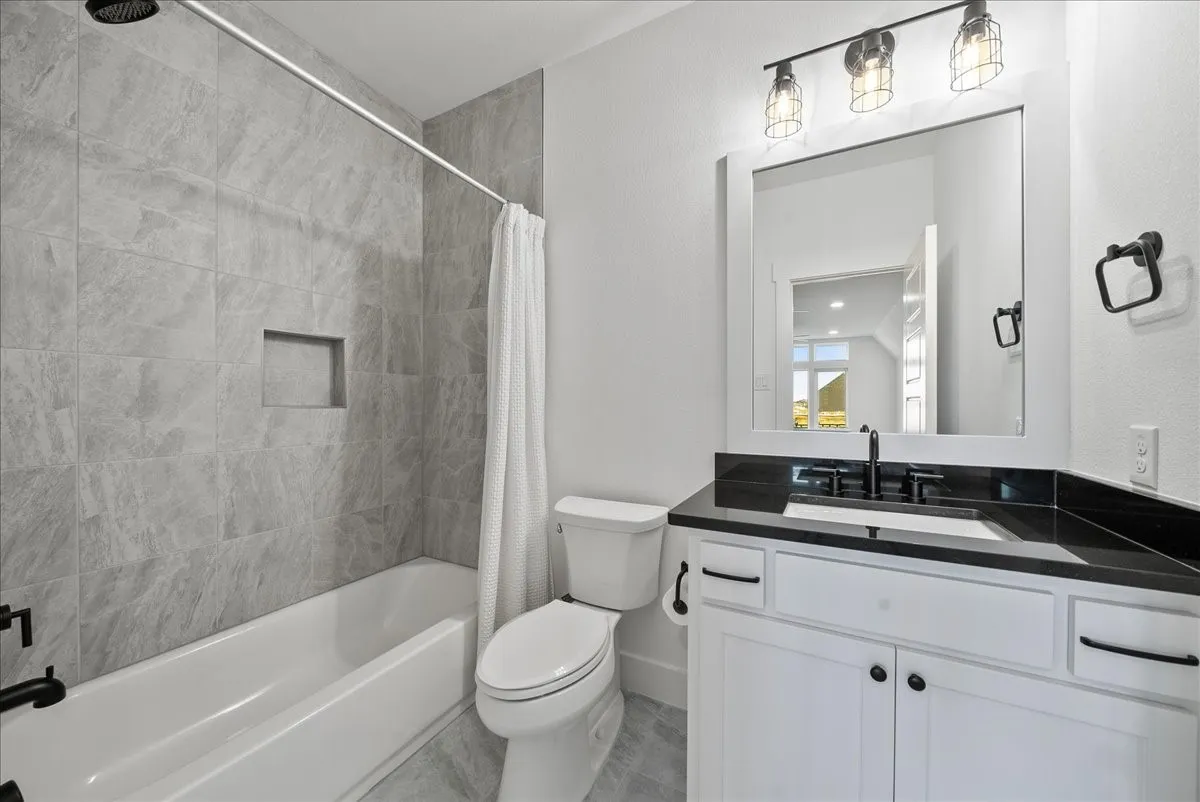 Full bathroom Upstairs featuring shower / bath combination with curtain, toilet, and vanity