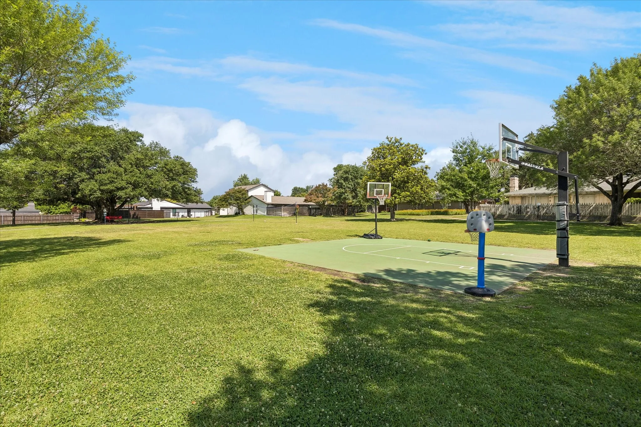 Large community greenbelt with tennis courts, pool, playground and sport court