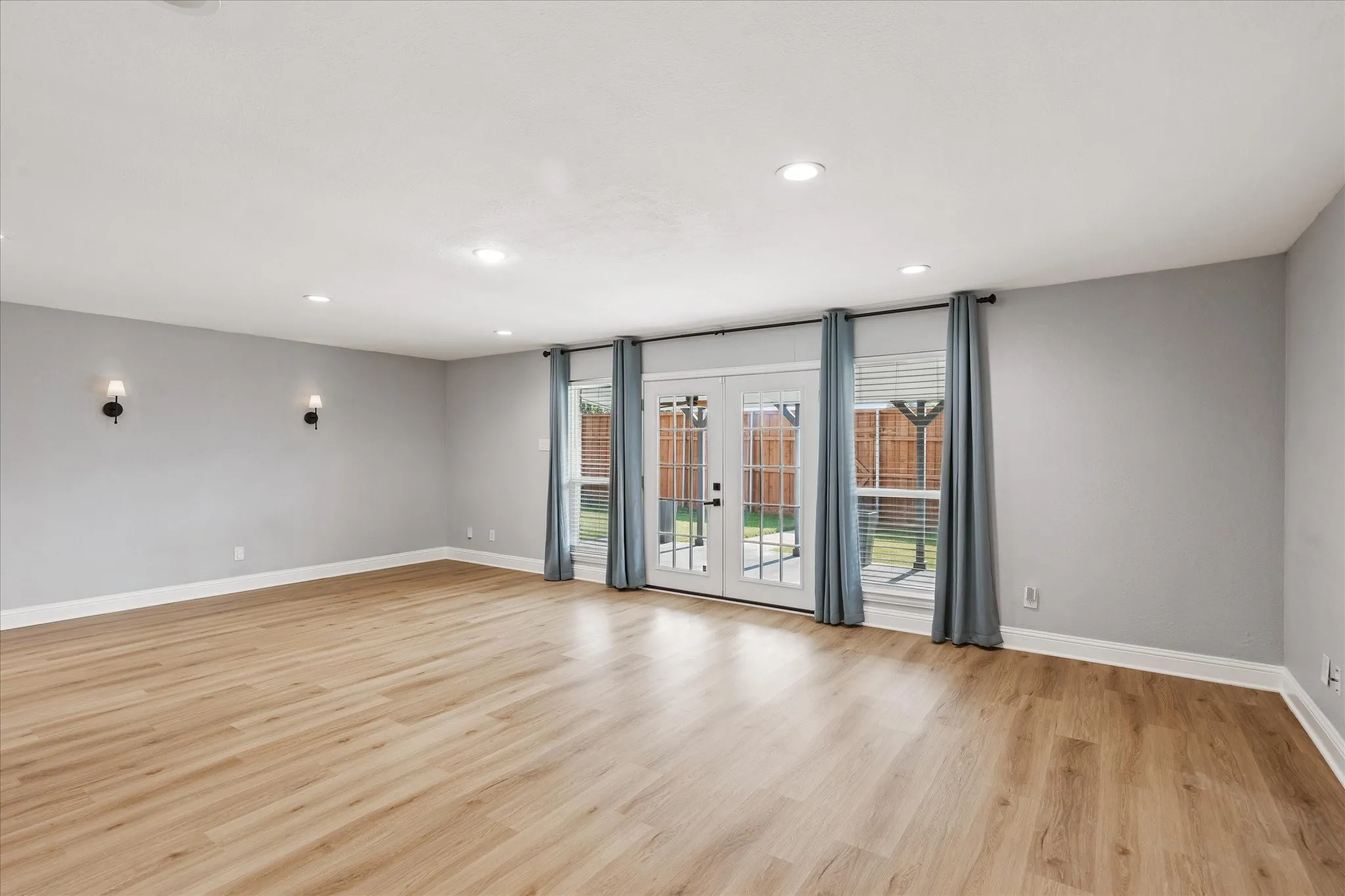 Spacious living room with French doors to the backyard