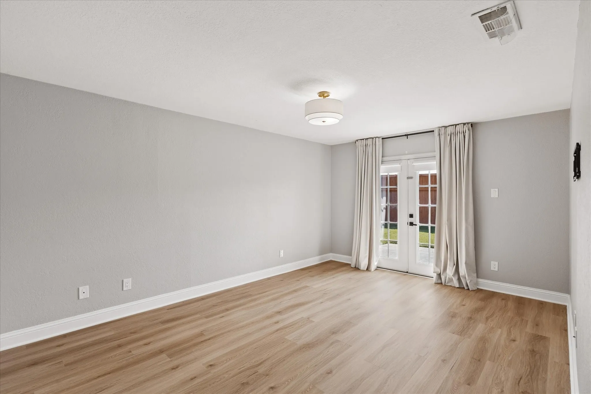 Primary bedroom with French Doors to the backyard