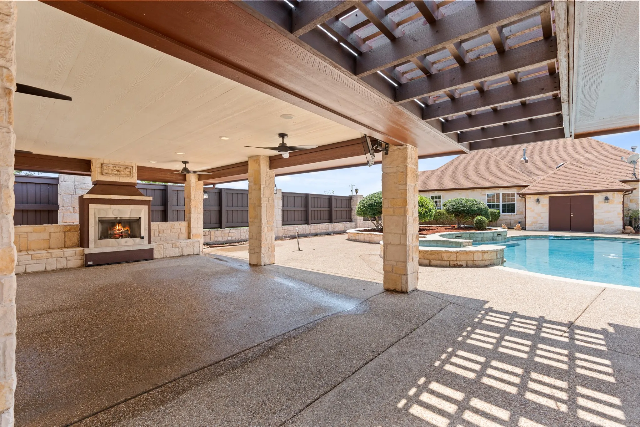 View of the pool and hot tub from pergola area designed for gathering