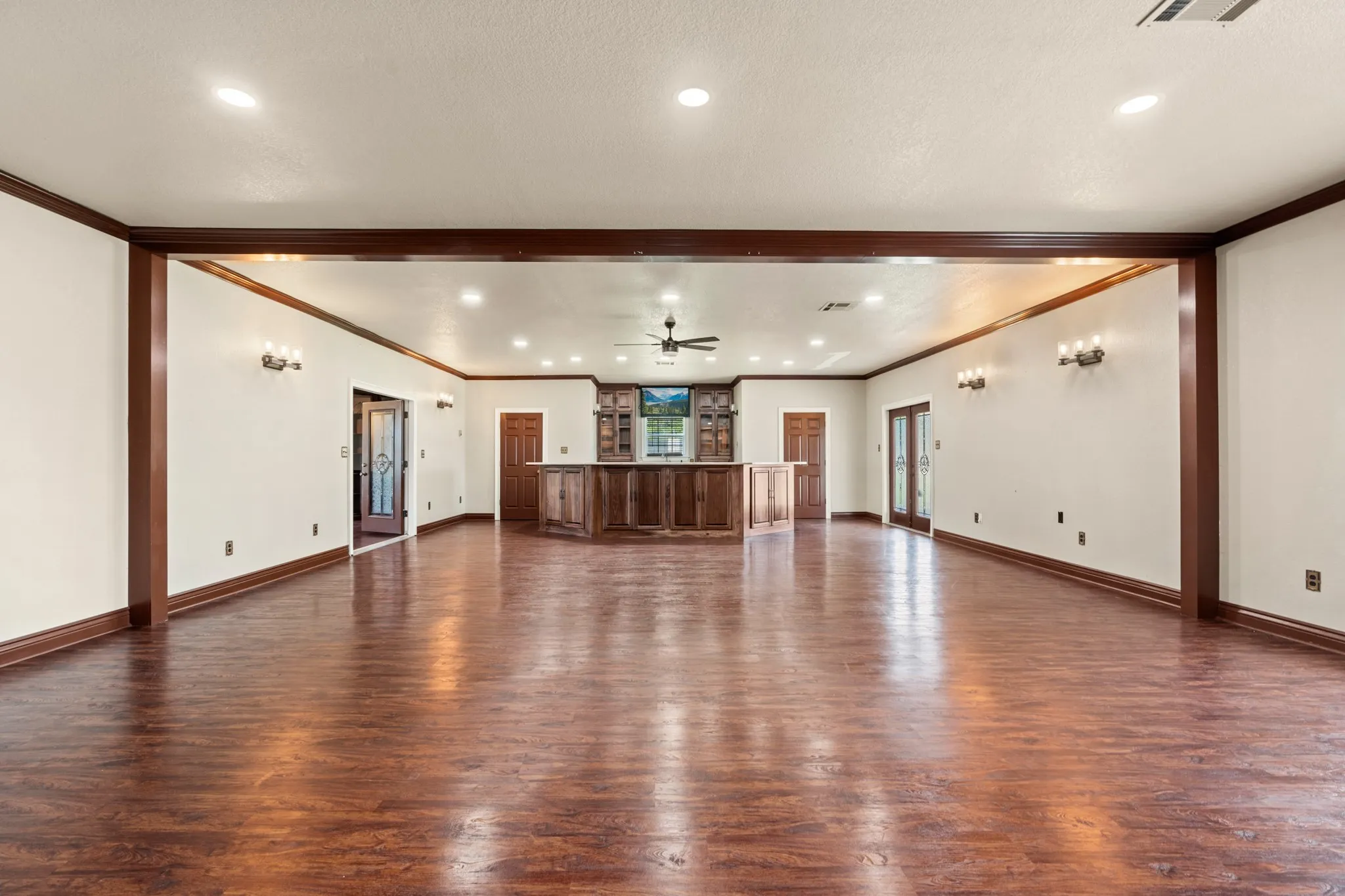 Event house has wine cellar, half bath, kitchen, and built in entertainment center area.