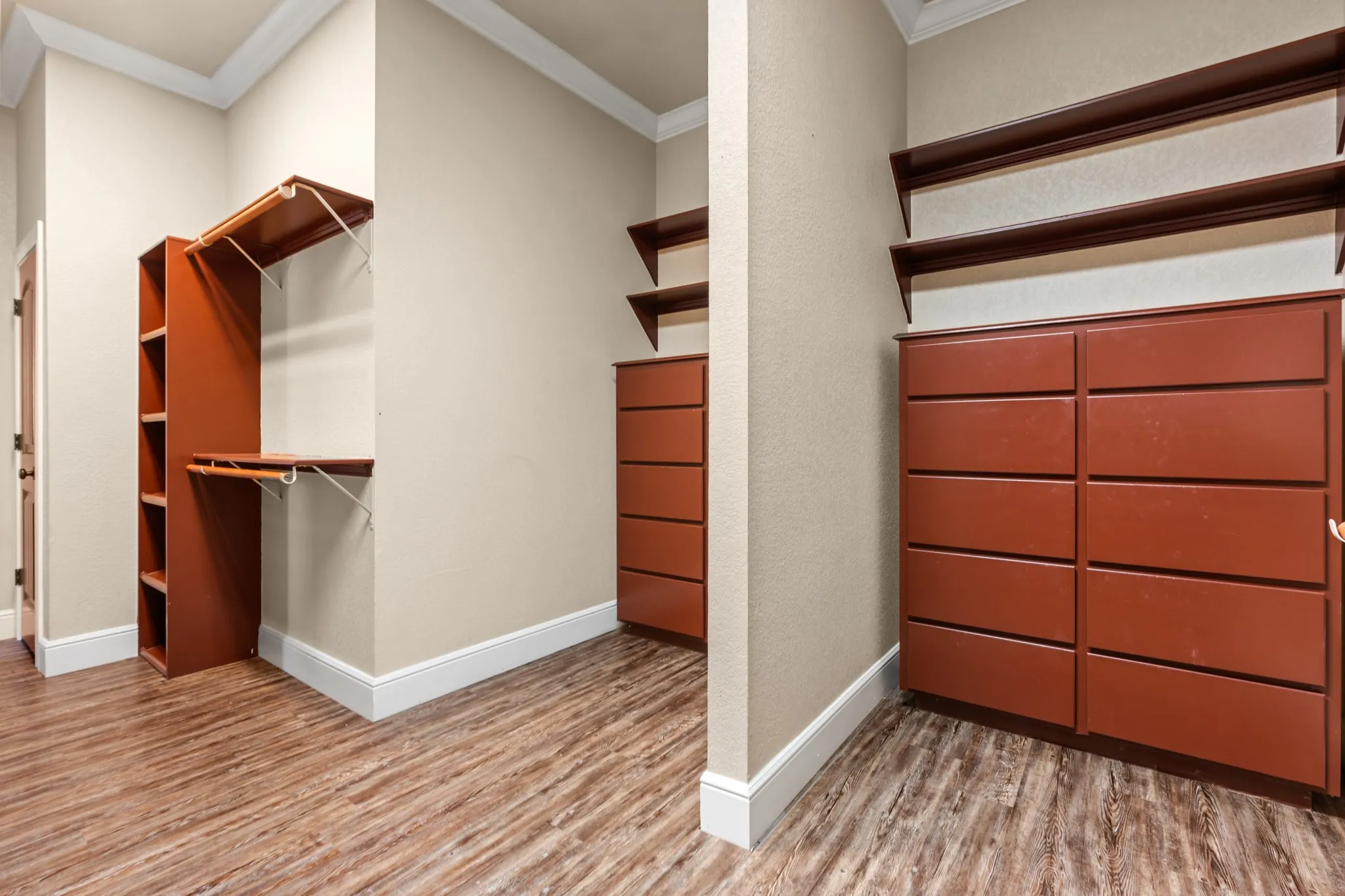 Walk in closet with built ins and plenty of storage.