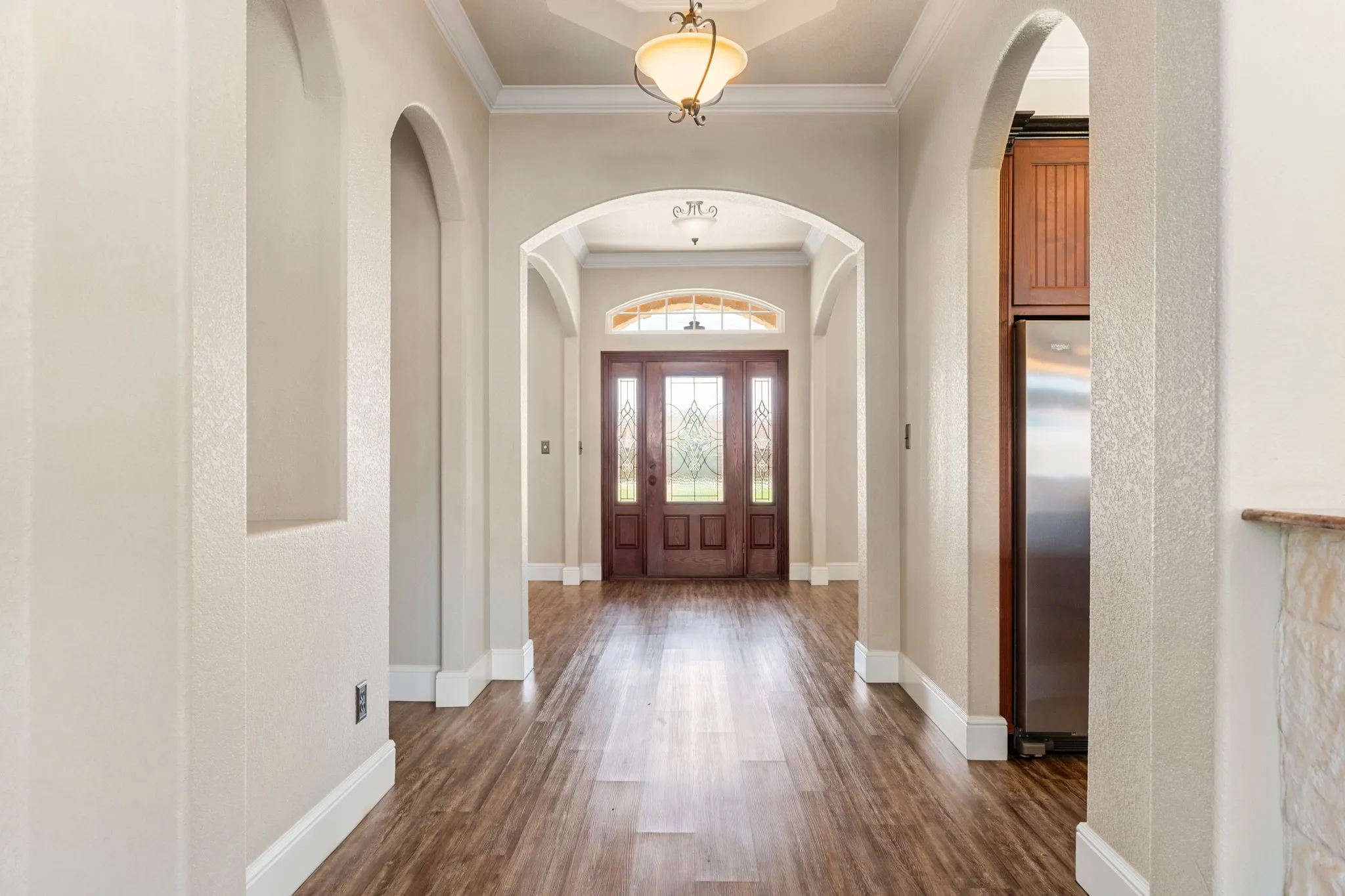 Entrance leading to open kitchen, dining, and living.