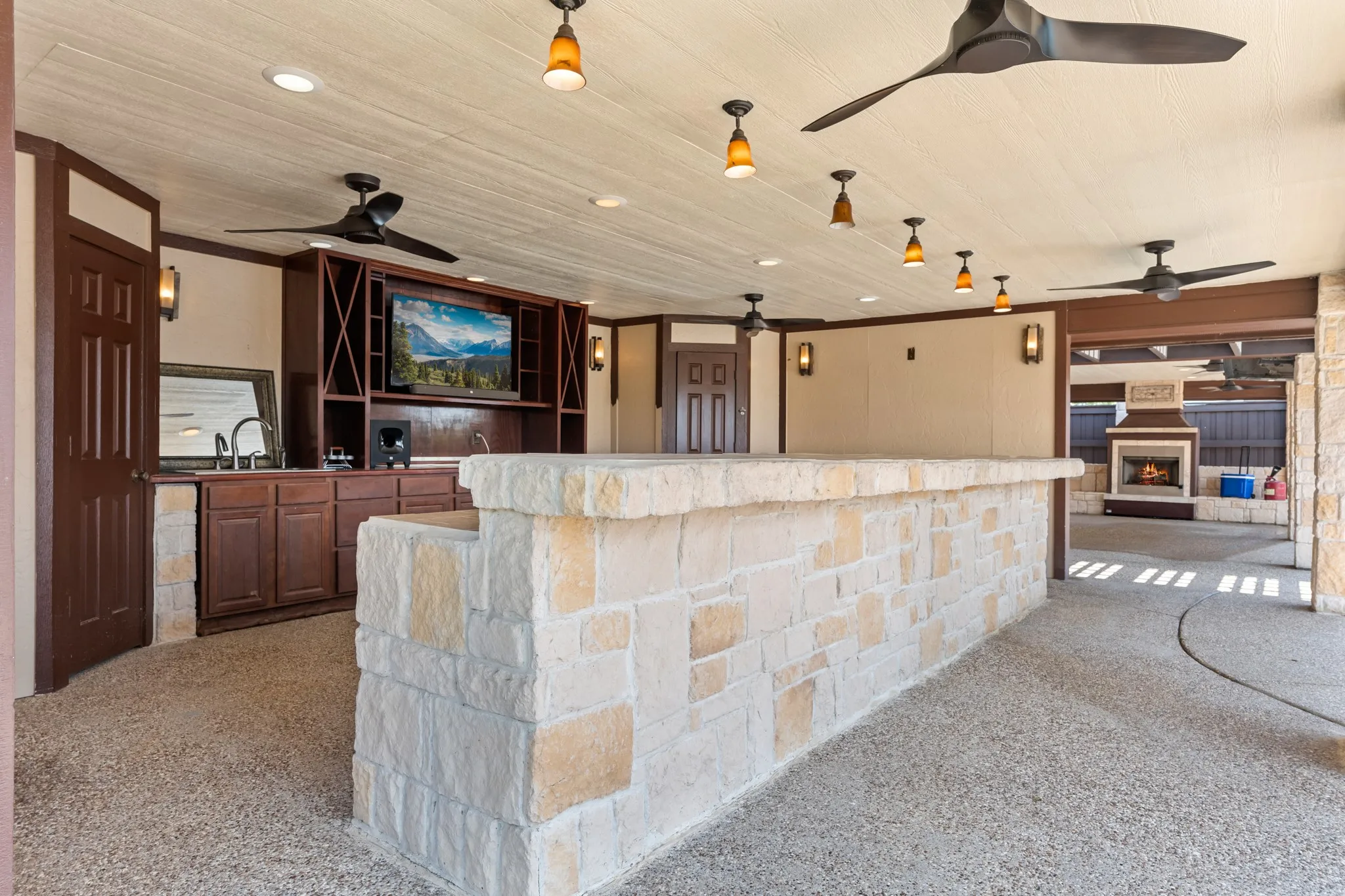 Outdoor bar attached to pergola.  Ceiling fans provide comfort on a hot day!