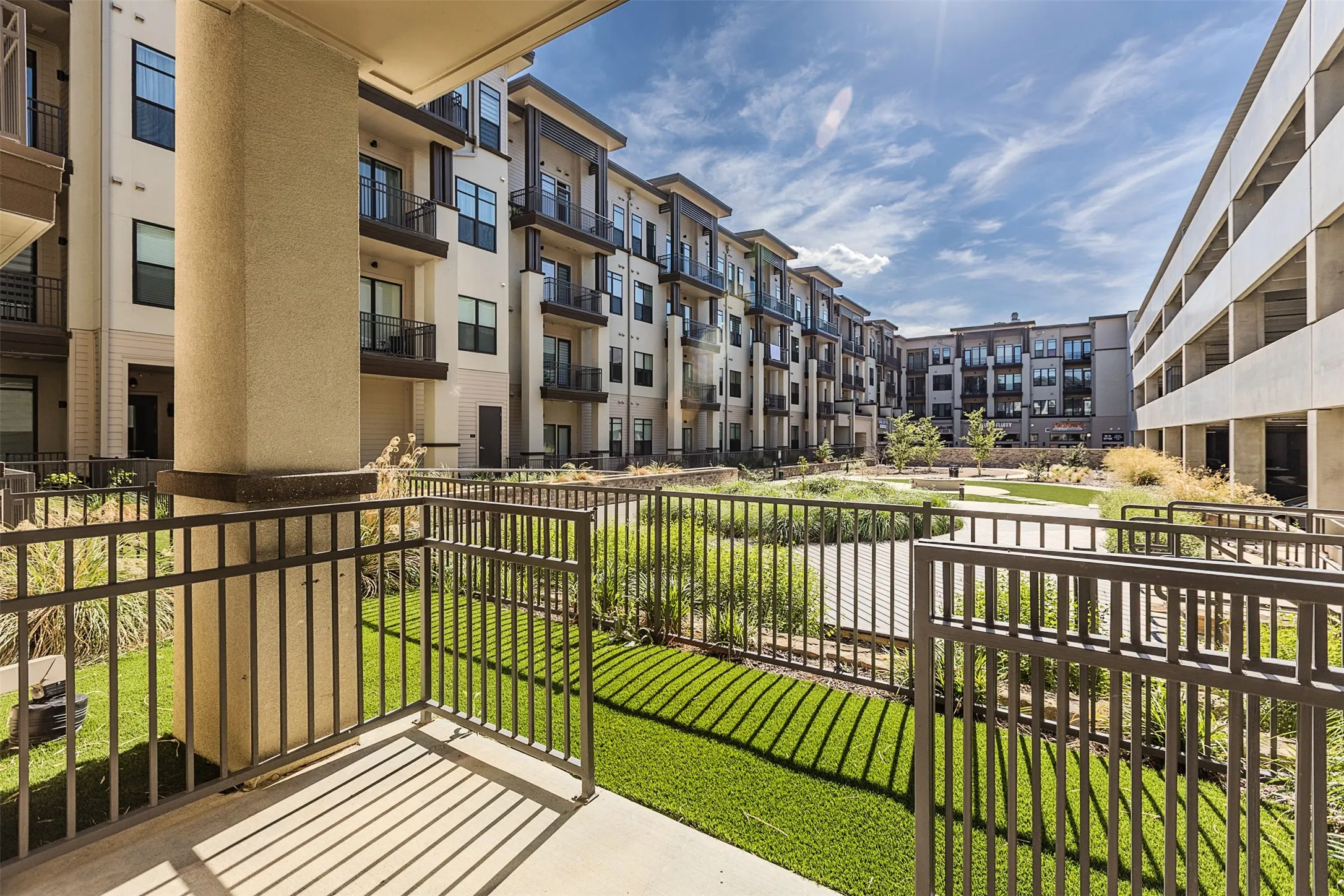 Private balcony with metal railings and concrete flooring