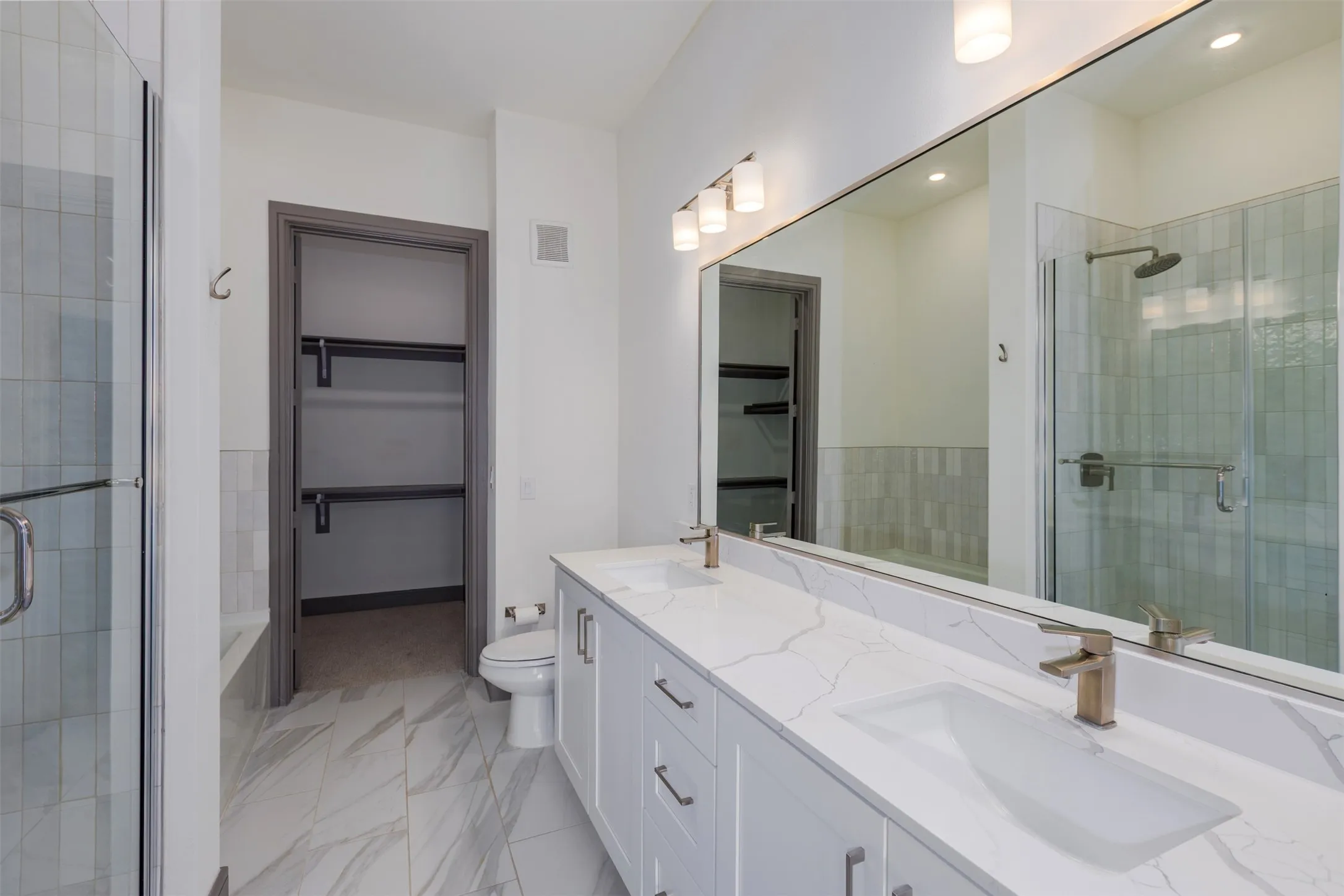 Dual vanity with white cabinetry and quartz countertops