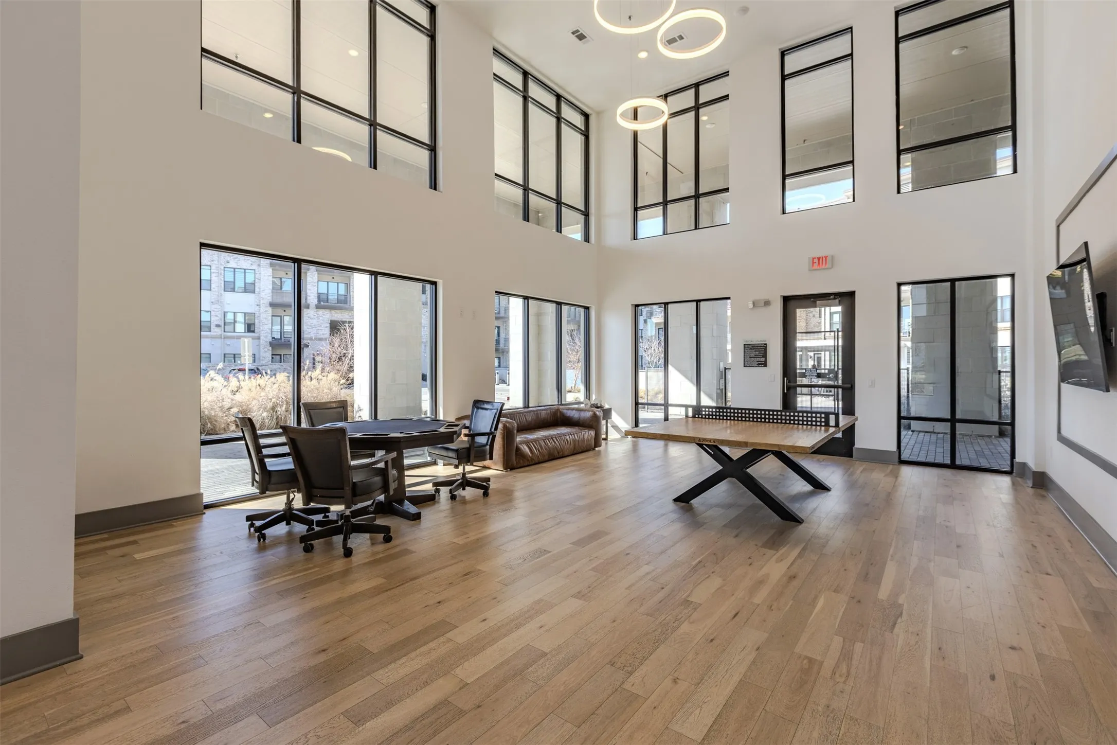 Spacious common area featuring high ceilings and extensive window walls