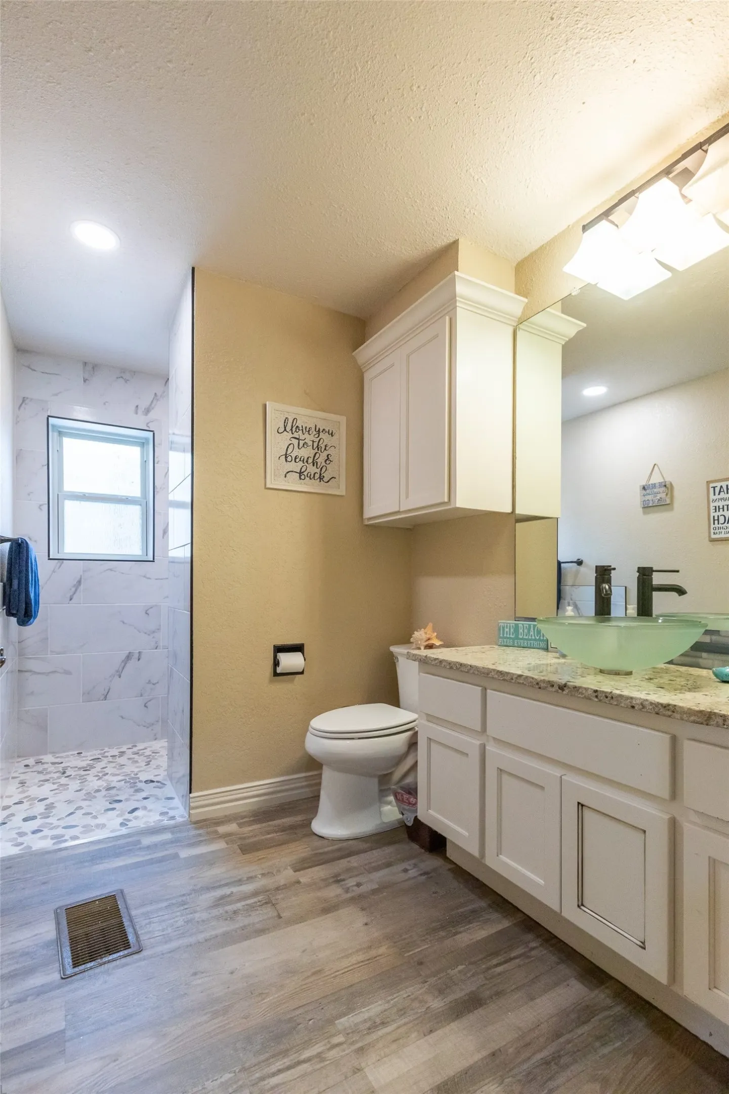 Completely remodeled in 2026, the downstairs bath adjoining a bedroom and for use as the guest bath.
