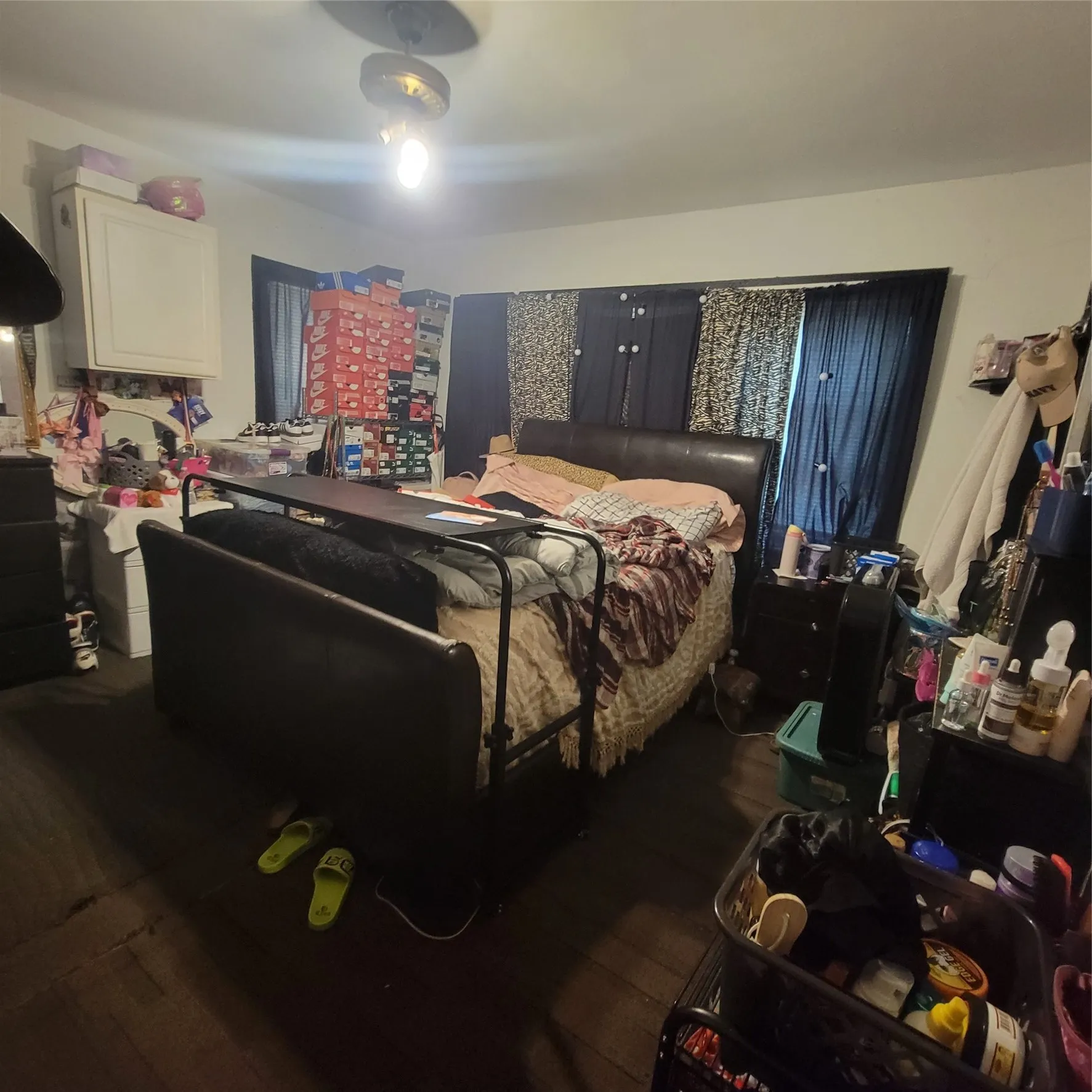 Bedroom featuring dark wood-finish flooring, white walls, and a ceiling-mounted light fixture