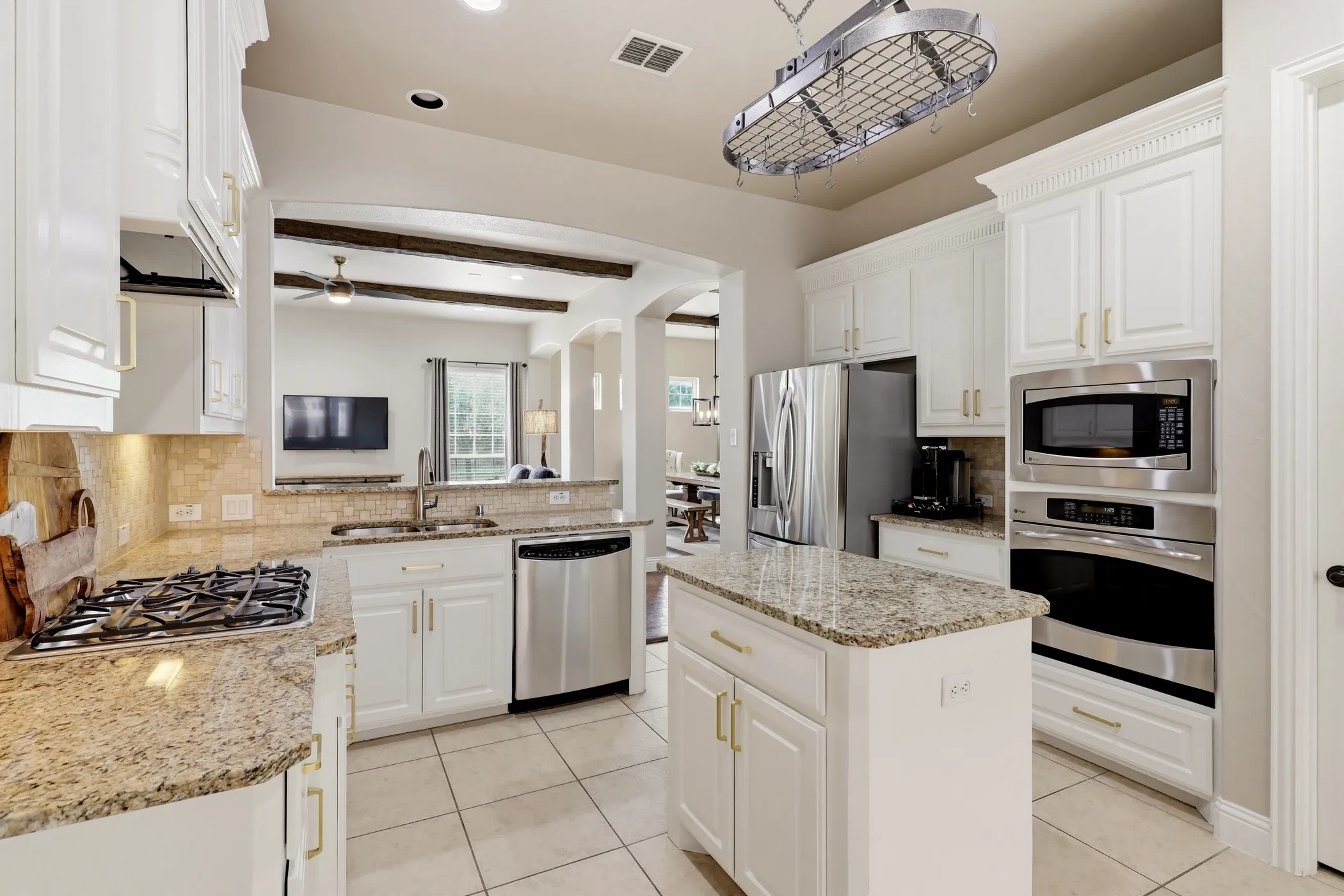 Island kitchen with granite counters & stainless appliances.