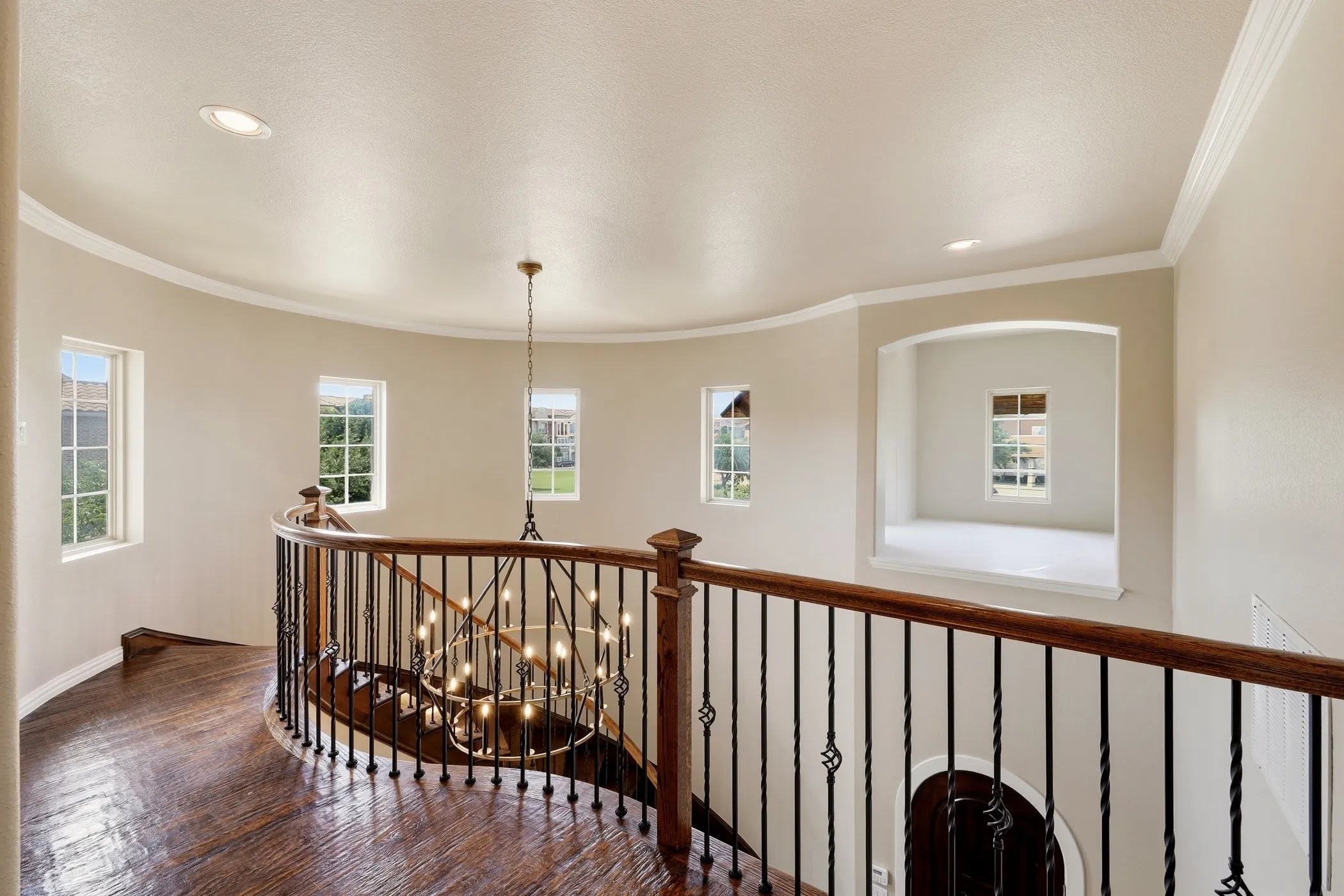 Elegant iron railing and hardwood floors on stairs and upstairs.