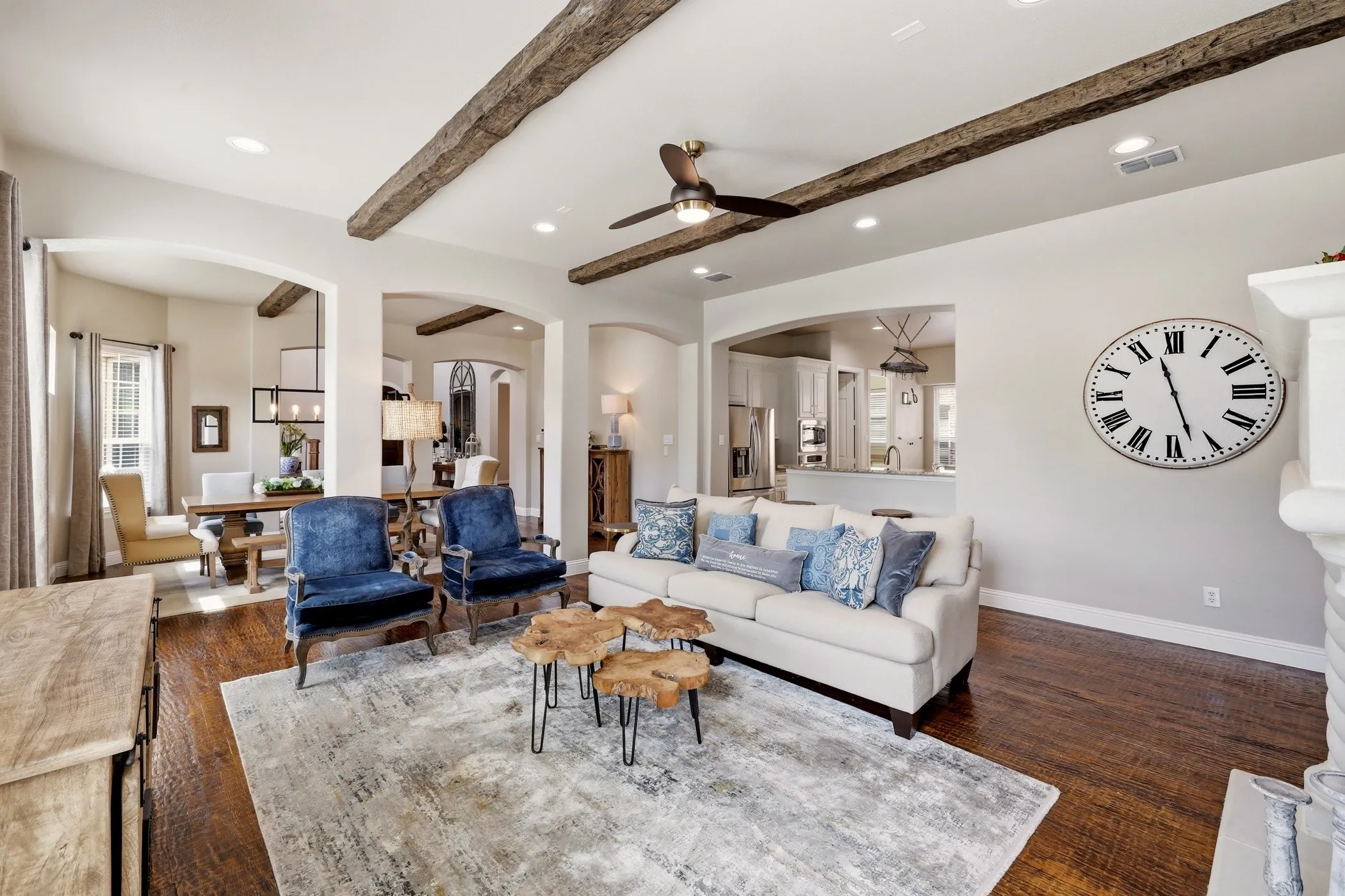 Open living room with gorgeous wood beams and wood floors.