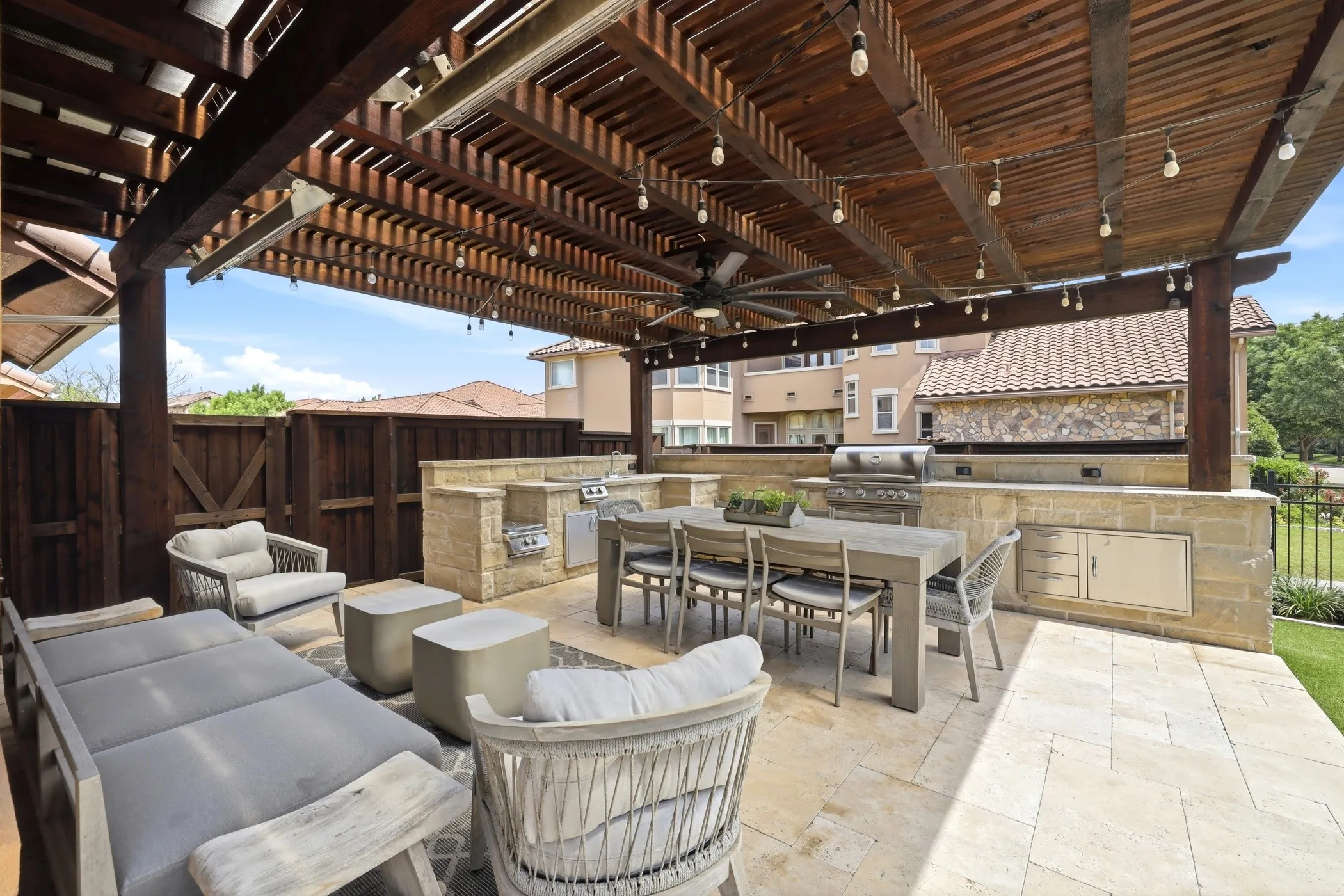 Covered pergola with outdoor kitchen.