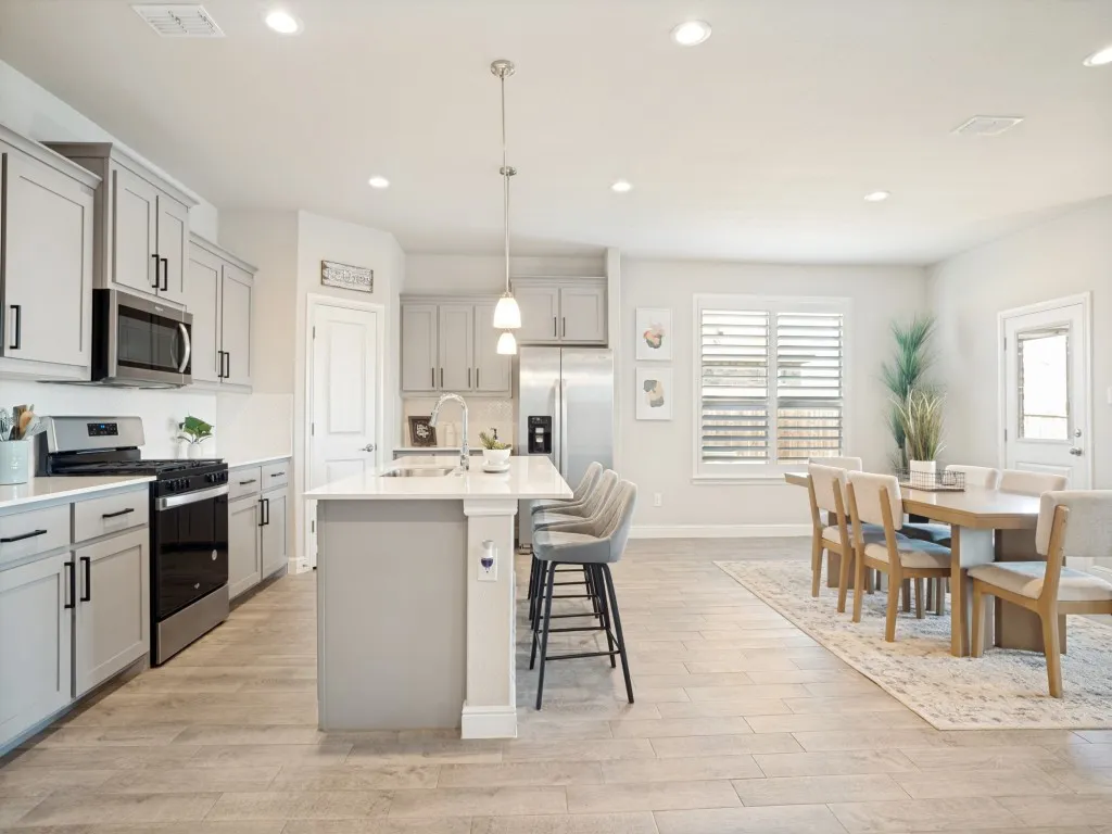 Open-concept kitchen and dining area featuring light wood-finish​​‌​​​​‌​​‌‌​‌‌​​​‌‌​‌​‌​‌​​​‌​​ flooring