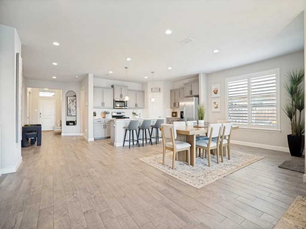 Open-concept living space featuring wood-finish flooring throughout